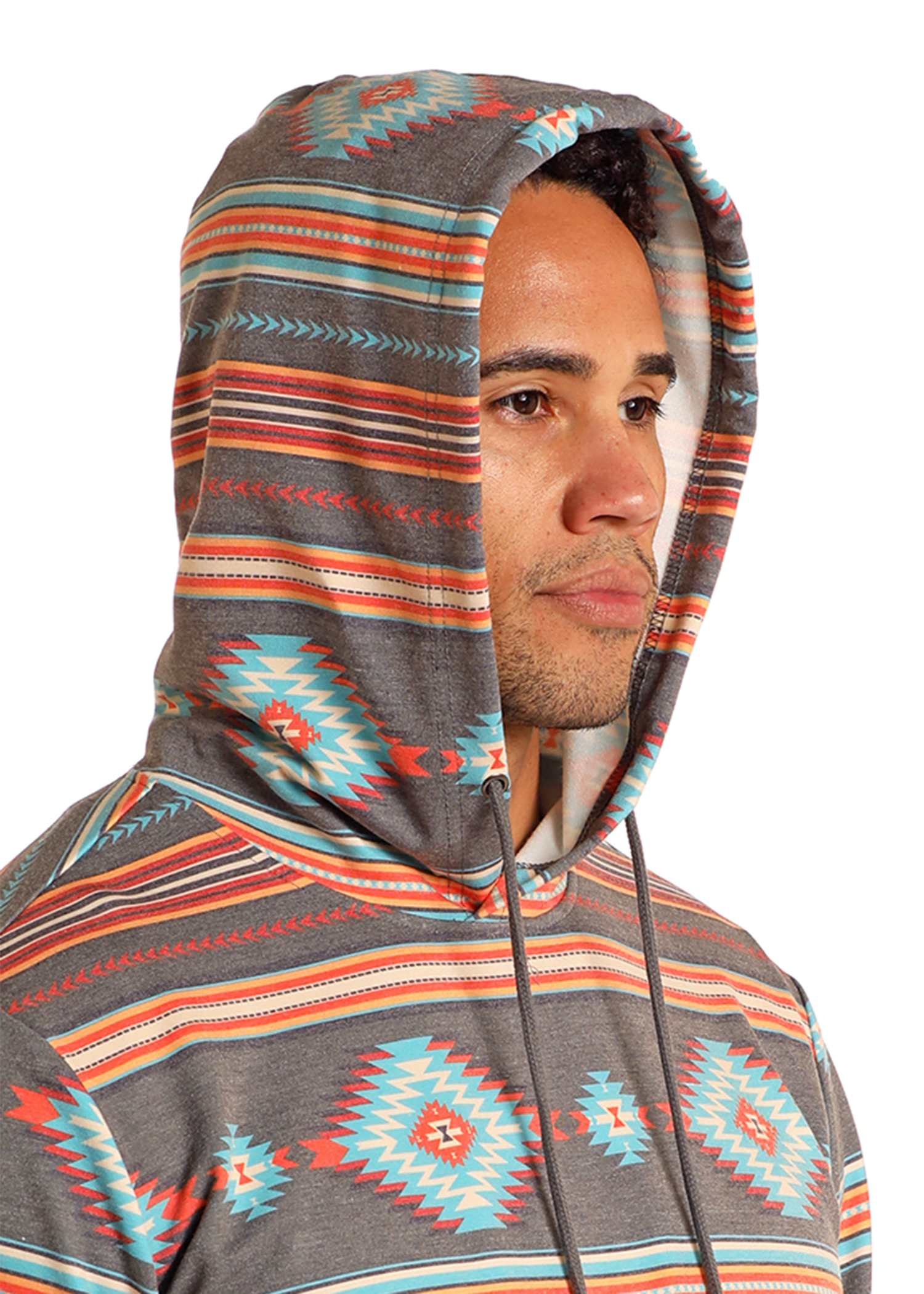 A person in a Rock & Roll Denim Grey Aztec Print Hoodie with turquoise, orange, and gray geometric patterns stands against a plain background, looking slightly to the side.