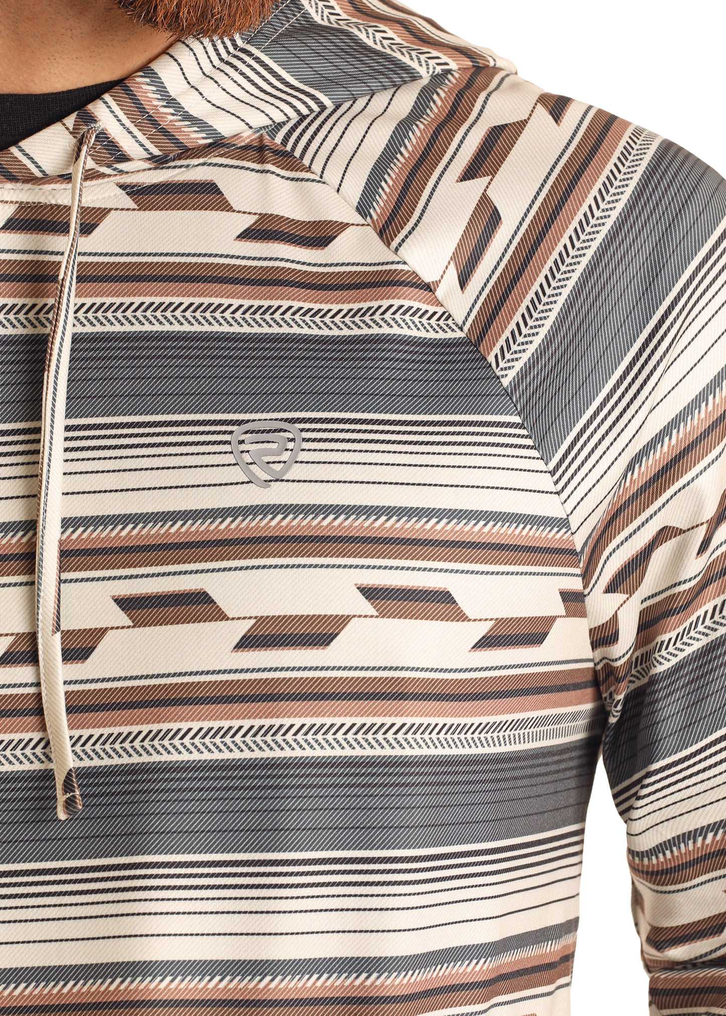 Close-up of a person wearing the Rock & Roll Denim Multi Stripe Performance Hoodie, featuring beige, brown, and black horizontal geometric stripes, a small chest logo, and comfortable stretch fabric. Only the upper torso and part of an arm are shown.