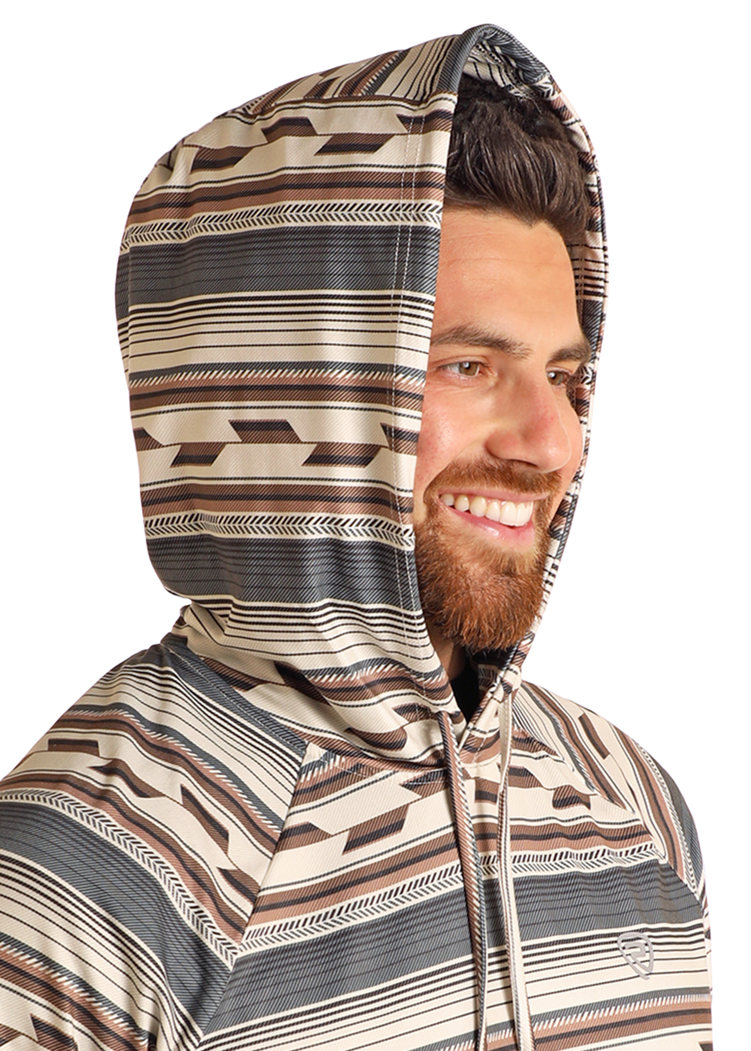 A bearded man smiles while wearing the Rock & Roll Denim Multi Stripe Performance Hoodie, designed with a brown, beige, and gray geometric pattern and comfortable stretch for everyday wear.