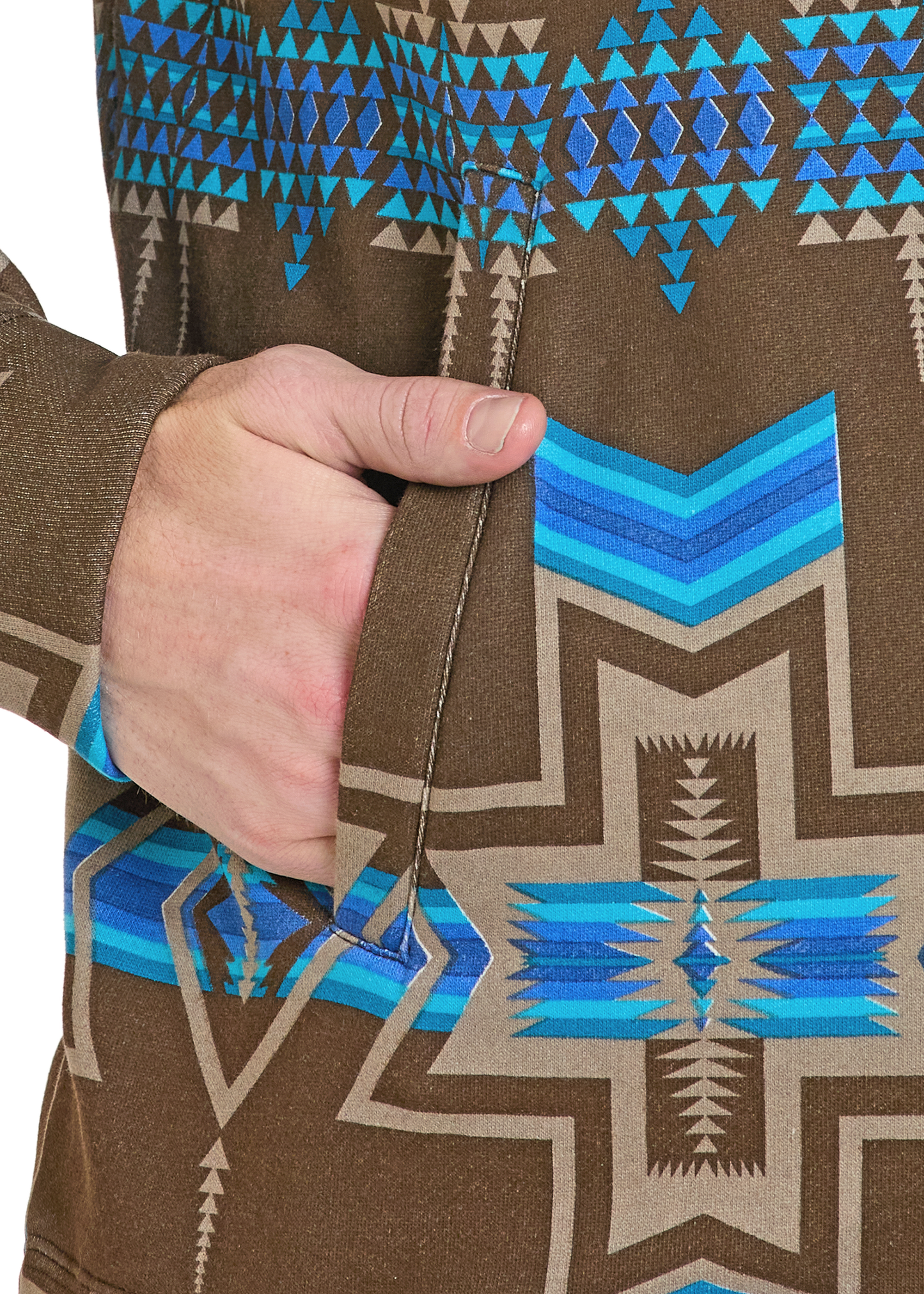 Close-up of a brown jacket with blue and beige geometric pattern, held by a hand.