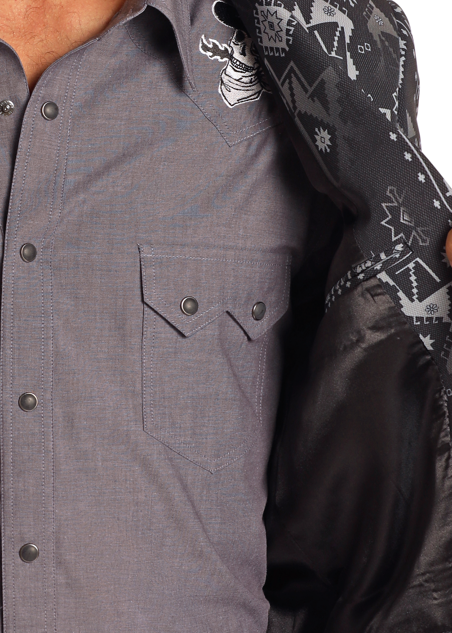 A person in a gray button-up shirt opens a Rock & Roll Denim Black Aztec Sport Coat, revealing its geometric pattern lining. Only the torso and part of the jacket are visible.