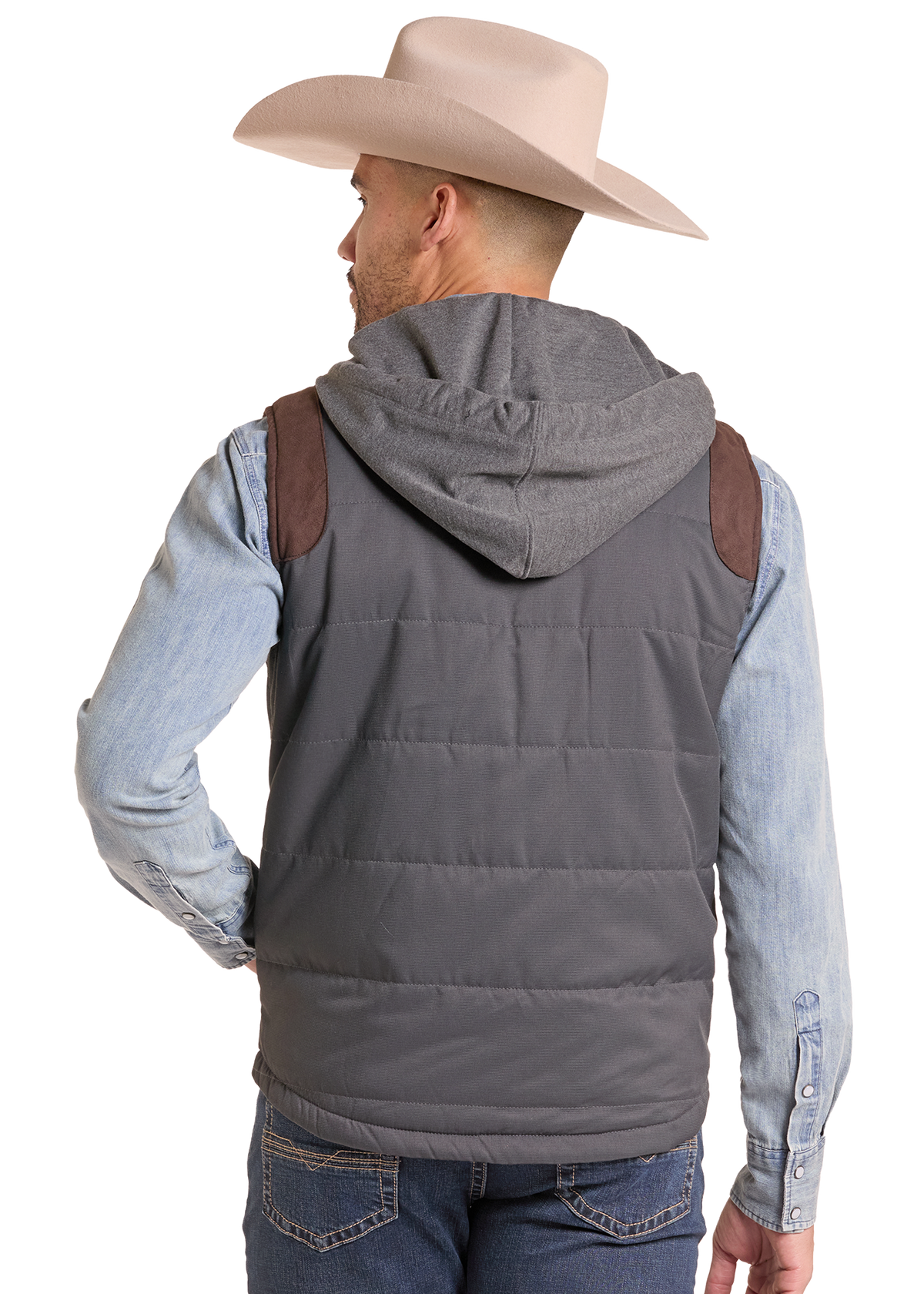 A man shown from the back wearing a gray hooded puffer vest with brown shoulder patches, a light blue denim shirt, and a beige cowboy hat against a white studio background.