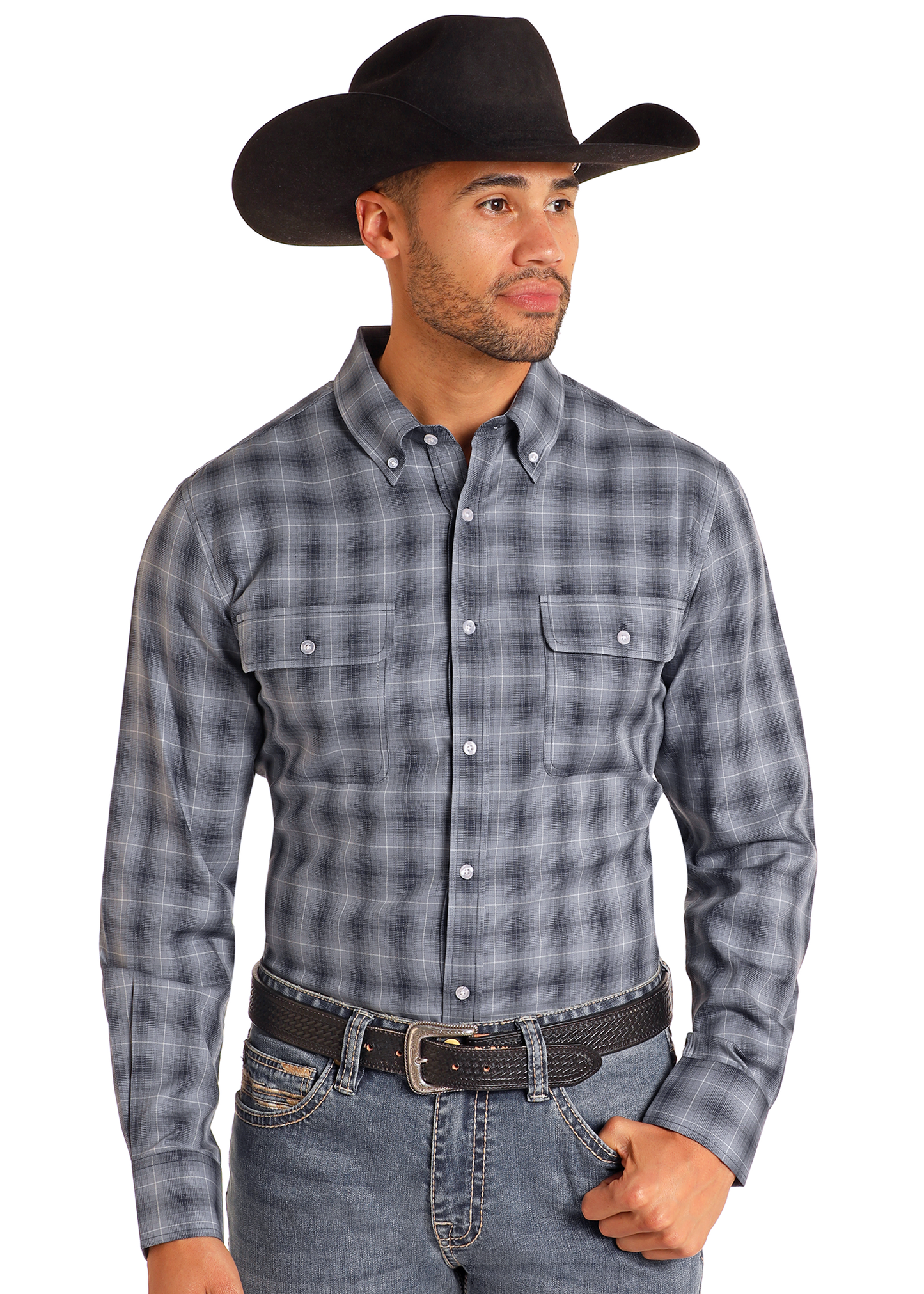 A man in a black cowboy hat, blue jeans, black belt, and the Rock & Roll Denim Slim Fit Indigo Plaid Long Sleeve Button Down Shirt stands against a plain white background, looking slightly to his left.