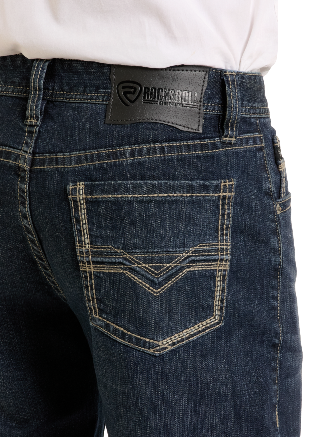 Back view of a person in High Rise Regular Fit Dark Wash Stackable Bootcut Jeans by Rock & Roll Denim, featuring white stitching, a brand patch on the waistband, and paired with a tucked-in white shirt.