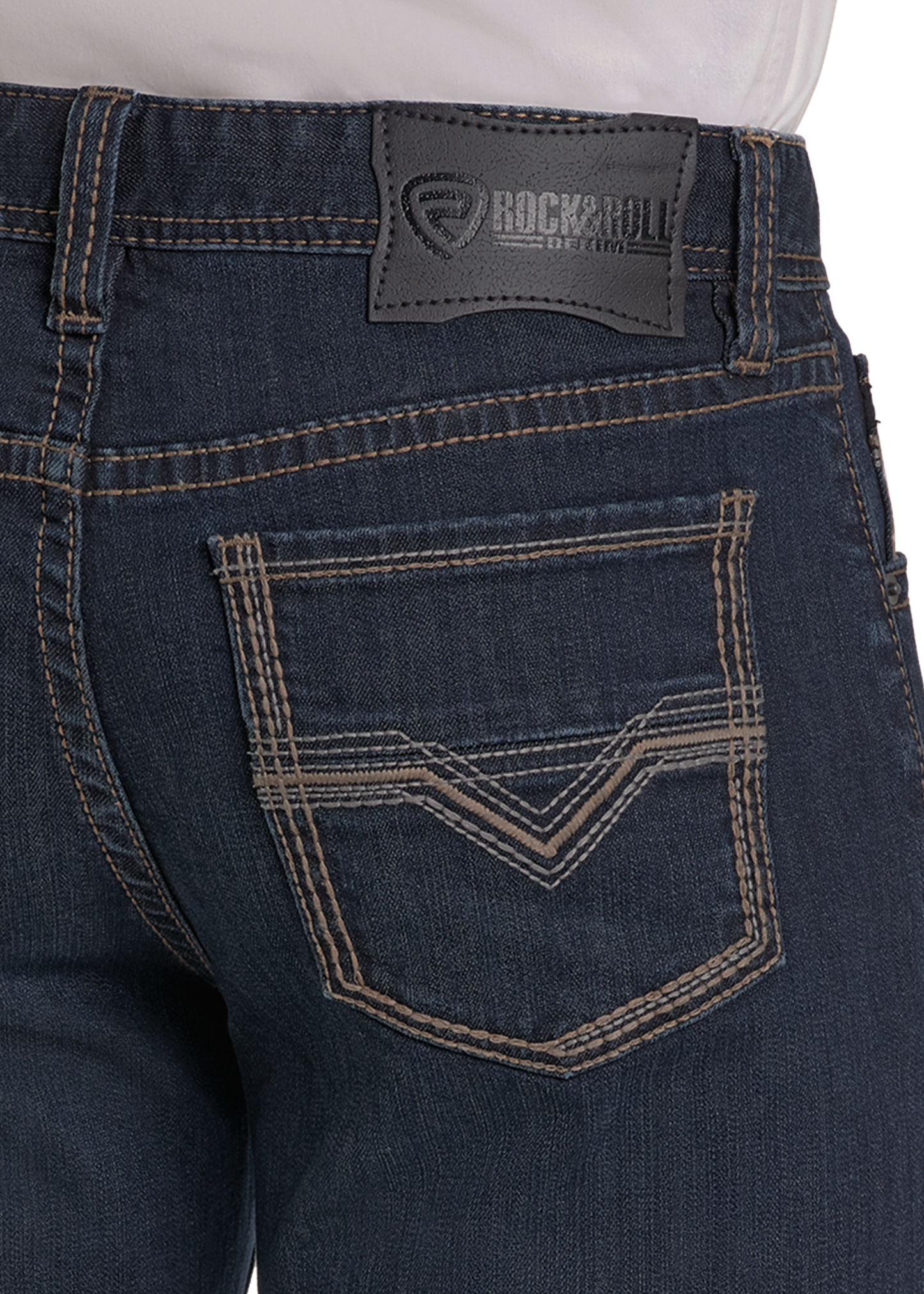 Close-up of the back of Rock & Roll Denim High Rise Regular Fit Tapered Bootcut Jeans in dark blue, featuring contrast stitching, a double-chevron pocket design, and a black brand label on the waistband. Styled with a white tucked-in shirt.