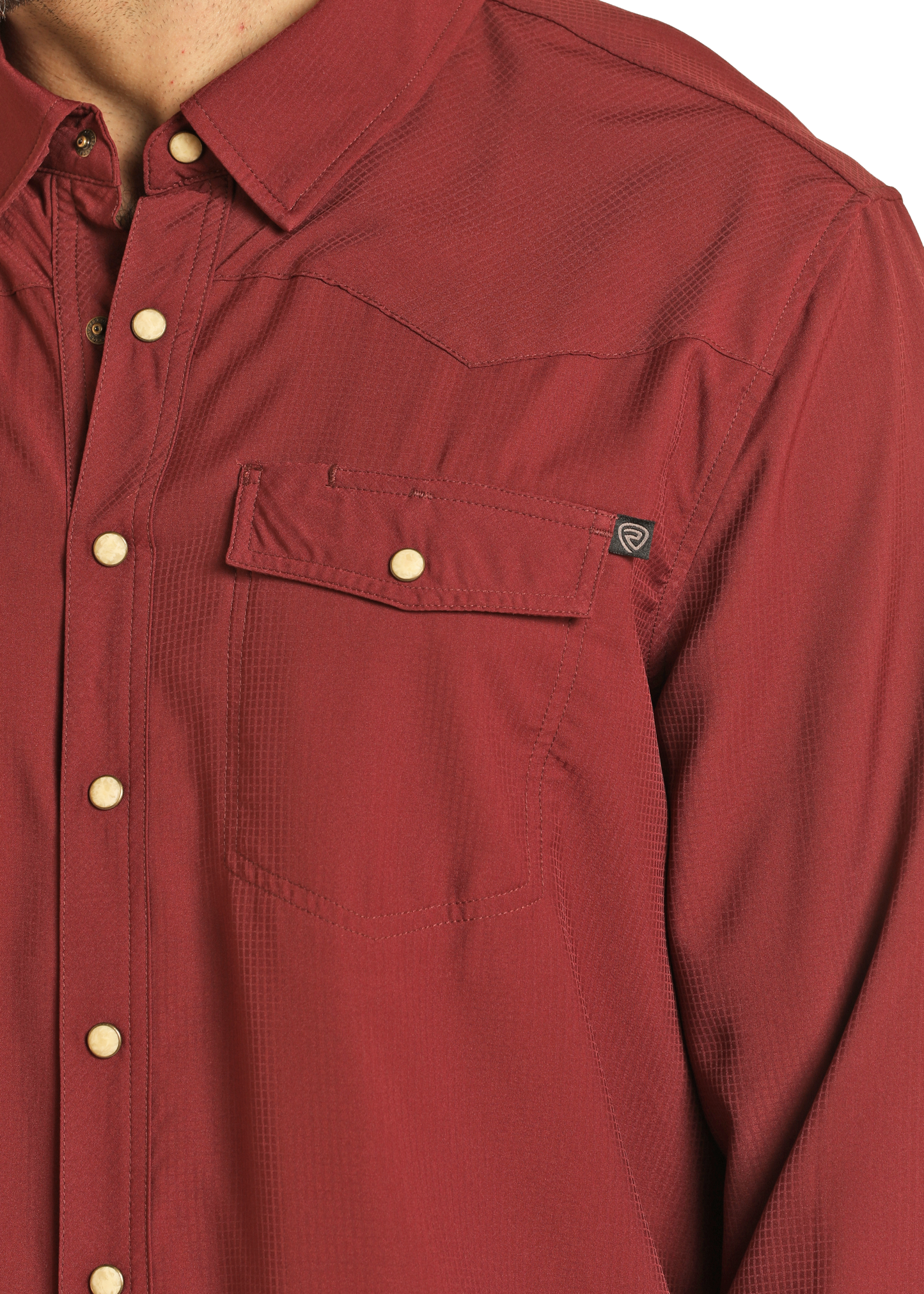 A person wears a Rock & Roll Denim TEK Western Maroon Long Sleeve Shirt featuring snap buttons and a flap chest pocket. Only their torso and part of their neck are visible against a plain background.