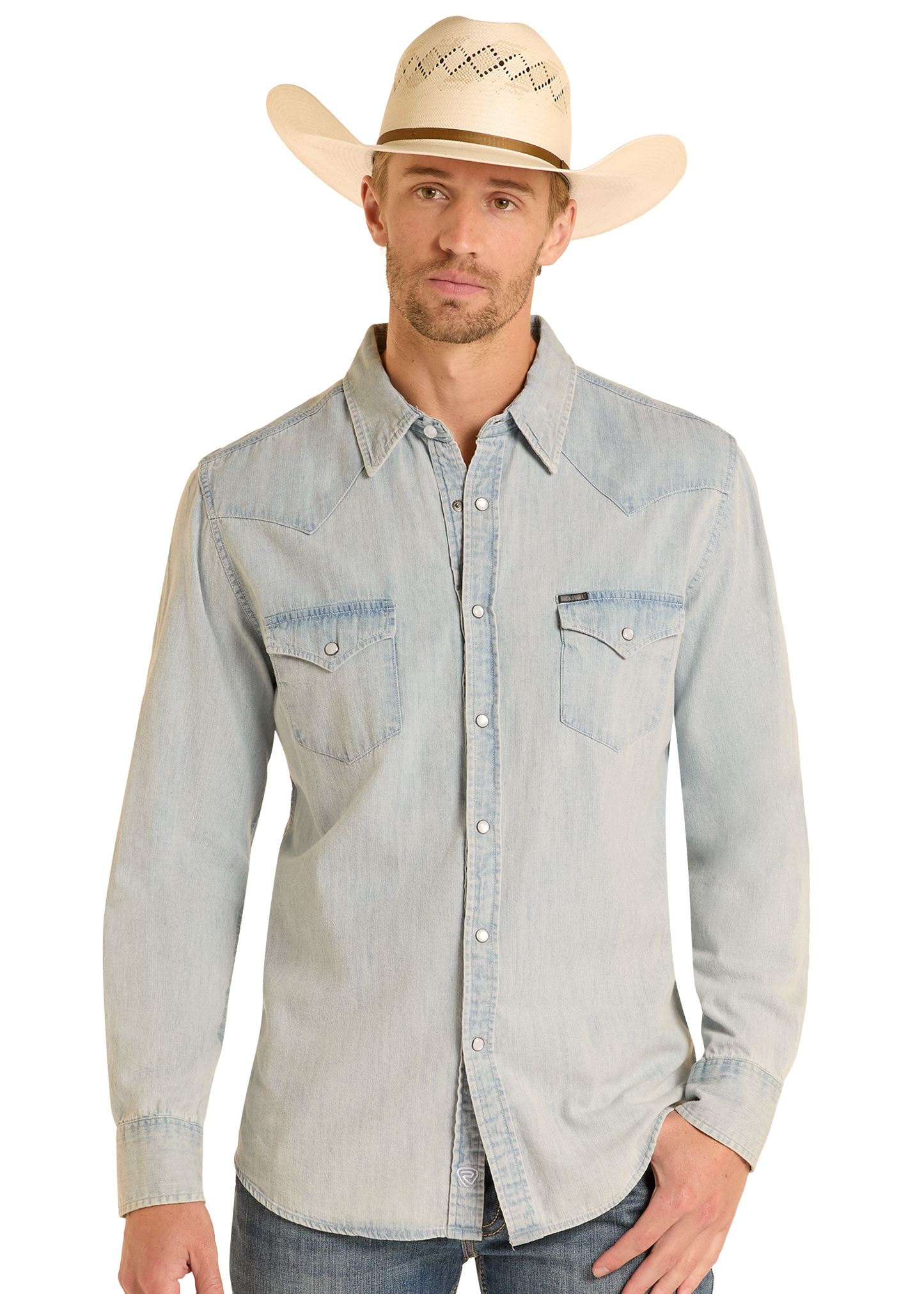 A man in a Rock & Roll Denim Slim Fit Light Wash Denim Snap Shirt with dual chest pockets and long sleeves, wearing a light cowboy hat, stands against a plain white background.
