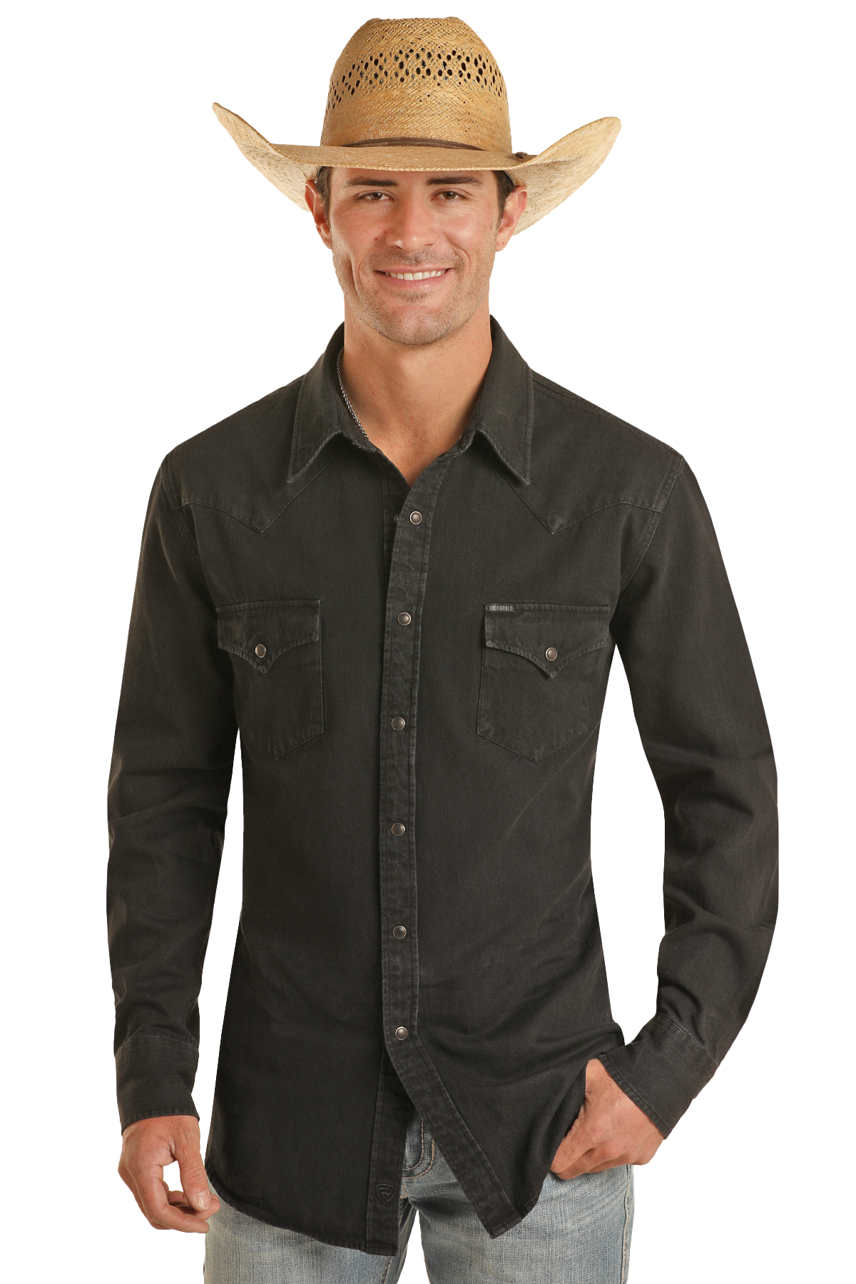 A man wearing the Rock & Roll Denim Slim Fit Black Wash Denim Snap Shirt stands smiling with one hand in his pocket against a plain white background.
