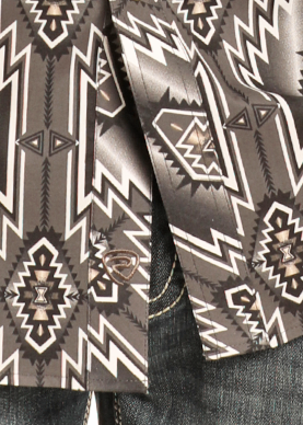 Close-up of the Rock & Roll Denim Slim Fit Black Striped Aztec Long Sleeve Snap Shirt, featuring a bold geometric southwestern pattern in black, gray, and white, partially draped over dark denim jeans.