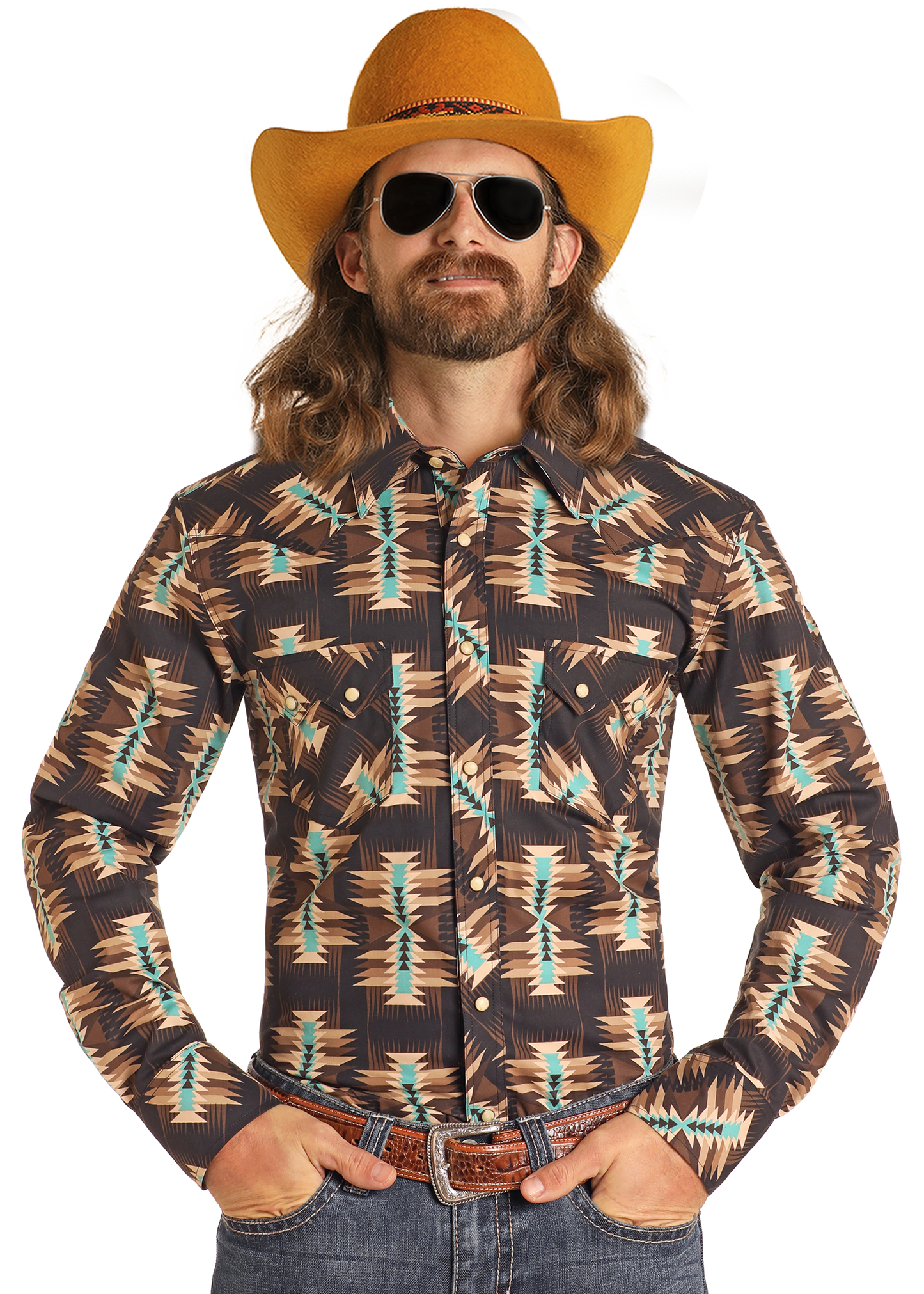 A man with long hair and a mustache wears a yellow cowboy hat, sunglasses, blue jeans, a brown belt, and the Rock & Roll Denim Dale Brisby Slim Fit Brown Aztec Long Sleeve Snap Shirt, standing with his hands in his pockets.