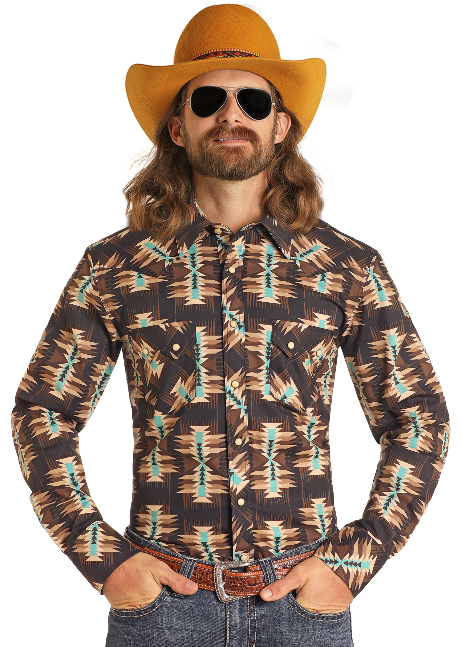 A man with long hair and a mustache wears a yellow cowboy hat, sunglasses, blue jeans, a brown belt, and the Rock & Roll Denim Dale Brisby Slim Fit Brown Aztec Long Sleeve Snap Shirt, standing with his hands in his pockets.