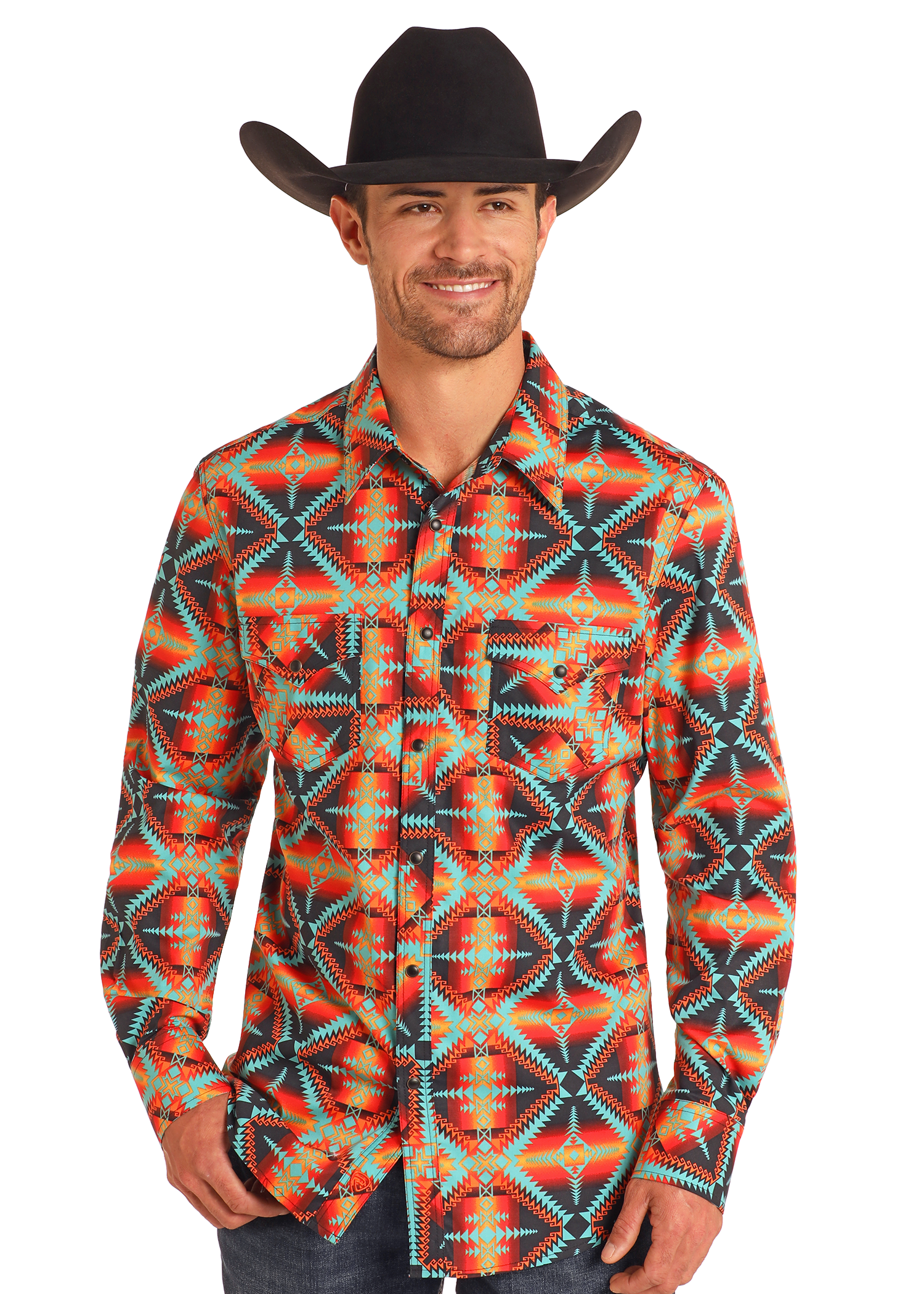 A man in a black cowboy hat and Rock & Roll Denim Slim Fit Red Aztec Long Sleeve Snap Shirt, featuring colorful geometric patterns, stands smiling against a plain white background.