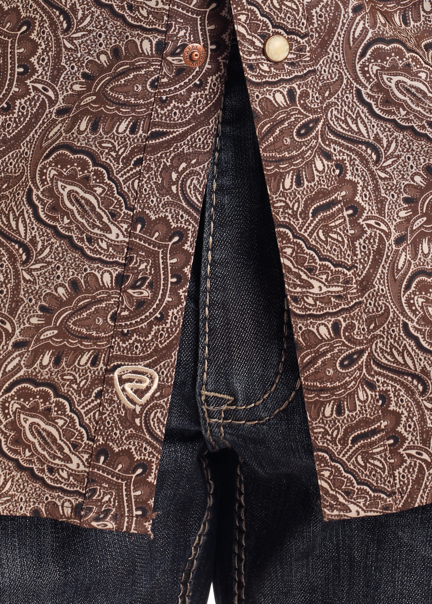 Close-up of a person wearing the Rock & Roll Denim Slim Fit Brown Paisley Print Long Sleeve Snap Shirt, featuring visible stitching and metal buttons, paired with dark blue denim jeans.