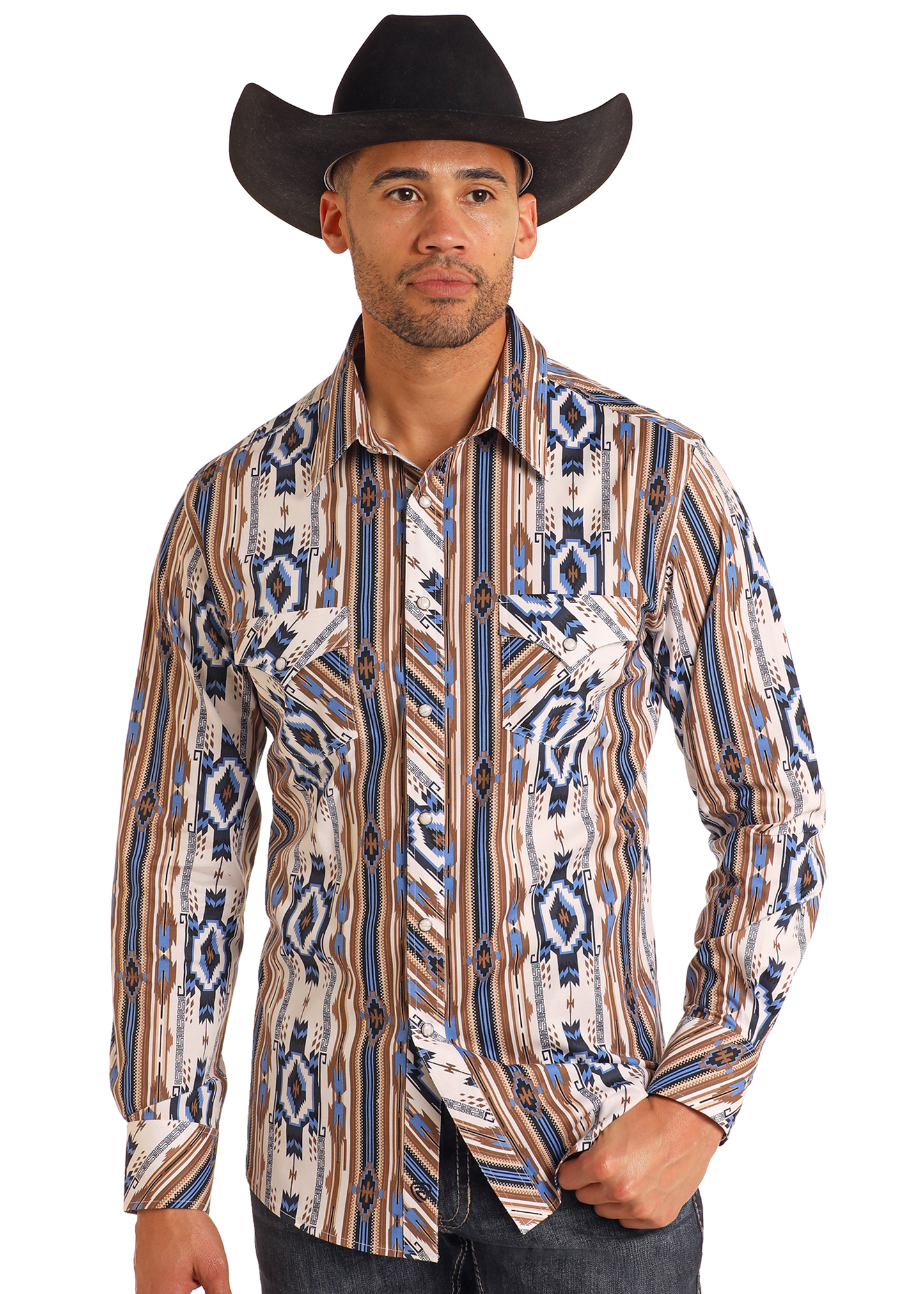 A man in a black cowboy hat, Rock & Roll Denim Slim Fit Tan Southwestern Striped Long Sleeve Snap Shirt, and dark jeans poses with one hand in his pocket against a plain background.