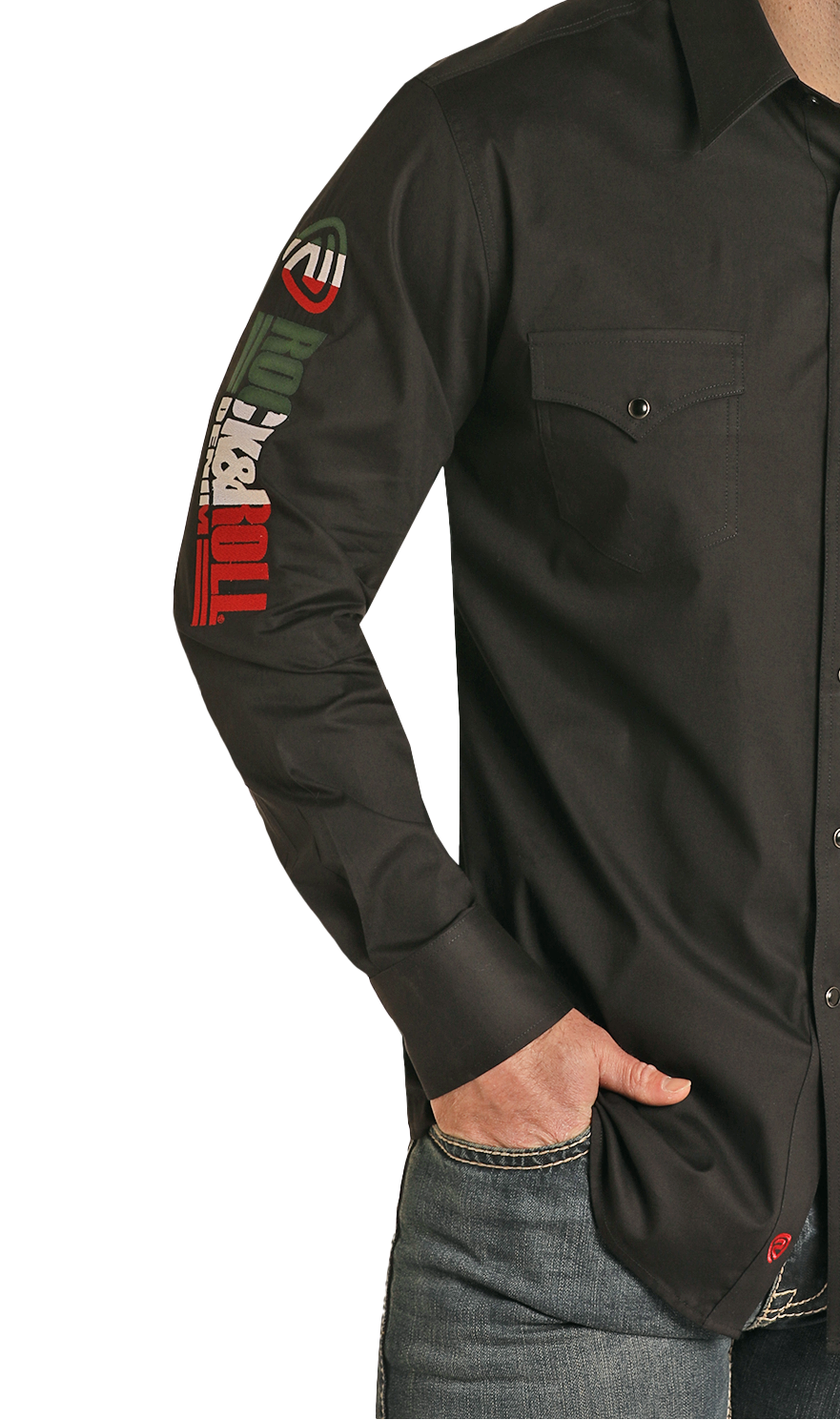 A person wears the Rock & Roll Denim Slim Fit Logo Long Sleeve Snap Shirt, featuring embroidered designs and text on the right sleeve and front chest pocket, with one hand in the pocket of their blue jeans.