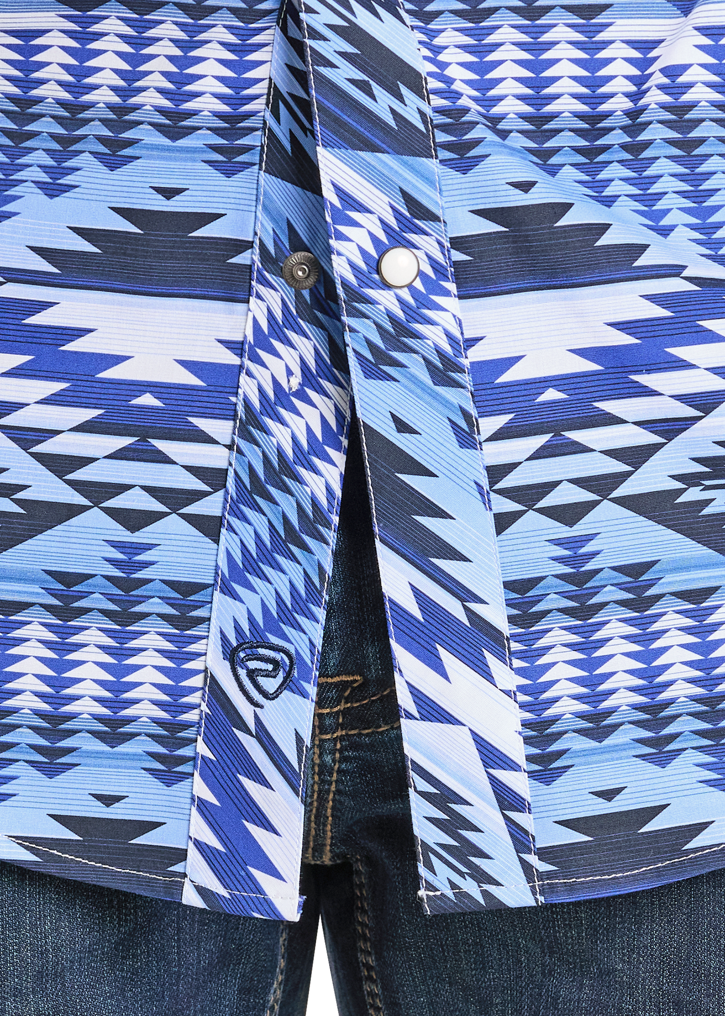 Close-up of the Rock & Roll Denim Slim Fit Diamond Aztec Long Sleeve Snap Shirt in blue and white geometric pattern, with double chest pockets and snap buttons, worn partially unbuttoned over dark blue jeans.