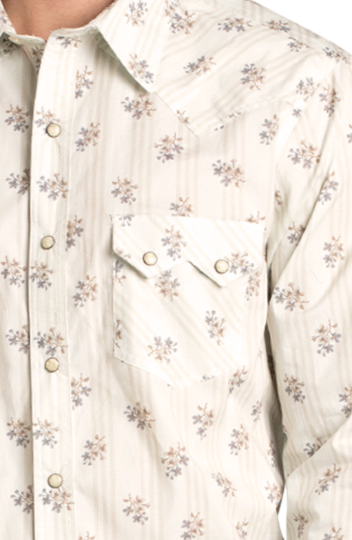 A close-up shows a person wearing the Rock & Roll Denim Slim Fit Floral Long Sleeve Snap Shirt—a cream shirt with a subtle floral print, metal snap buttons, and pointed flap chest pocket. Only the upper torso is visible.