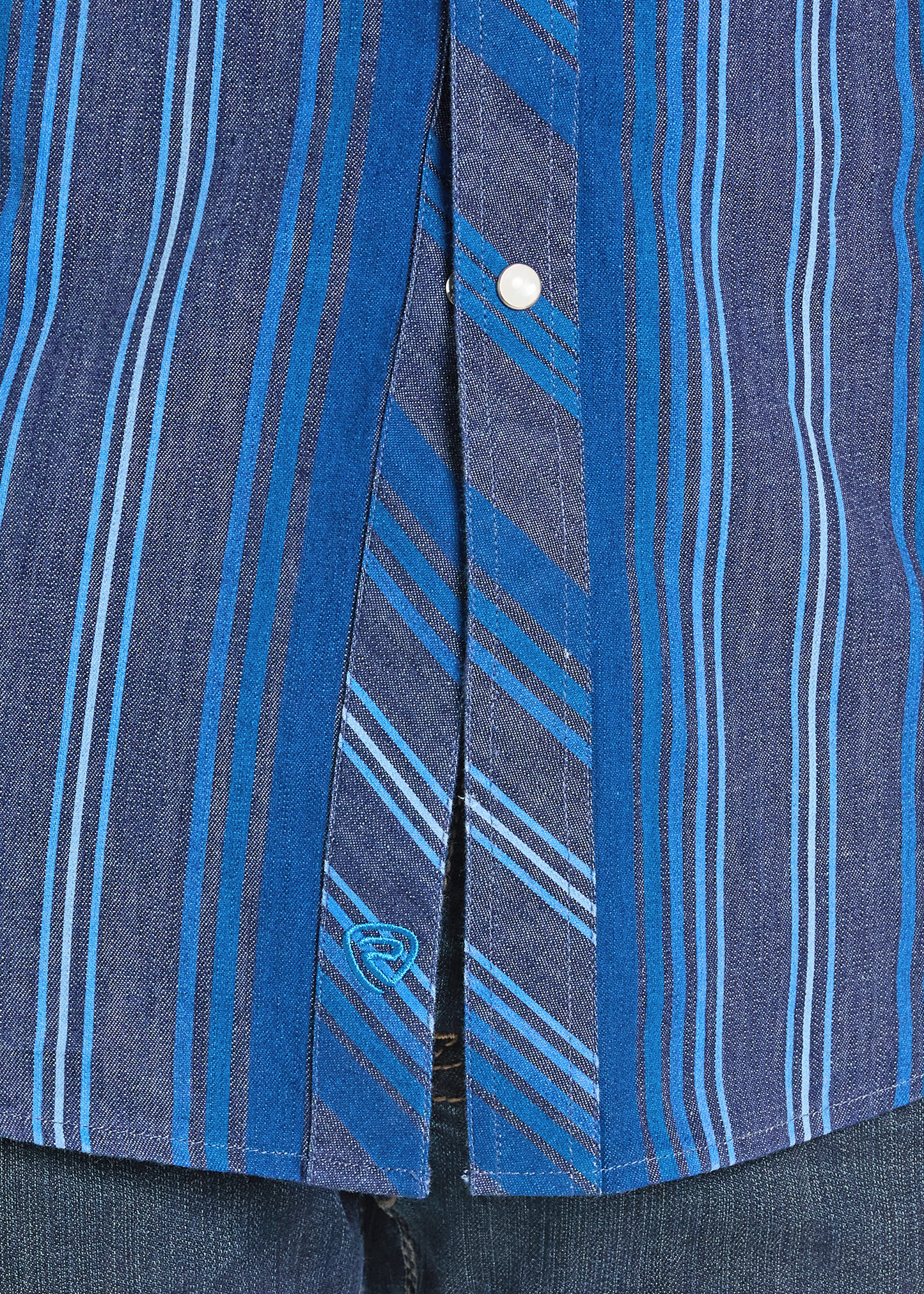 Close up of a western pearl snap shirt.
