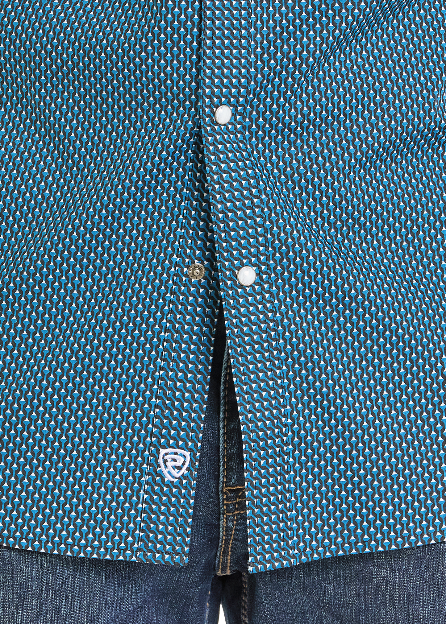 Close up of a geometric pearl snap shirt.