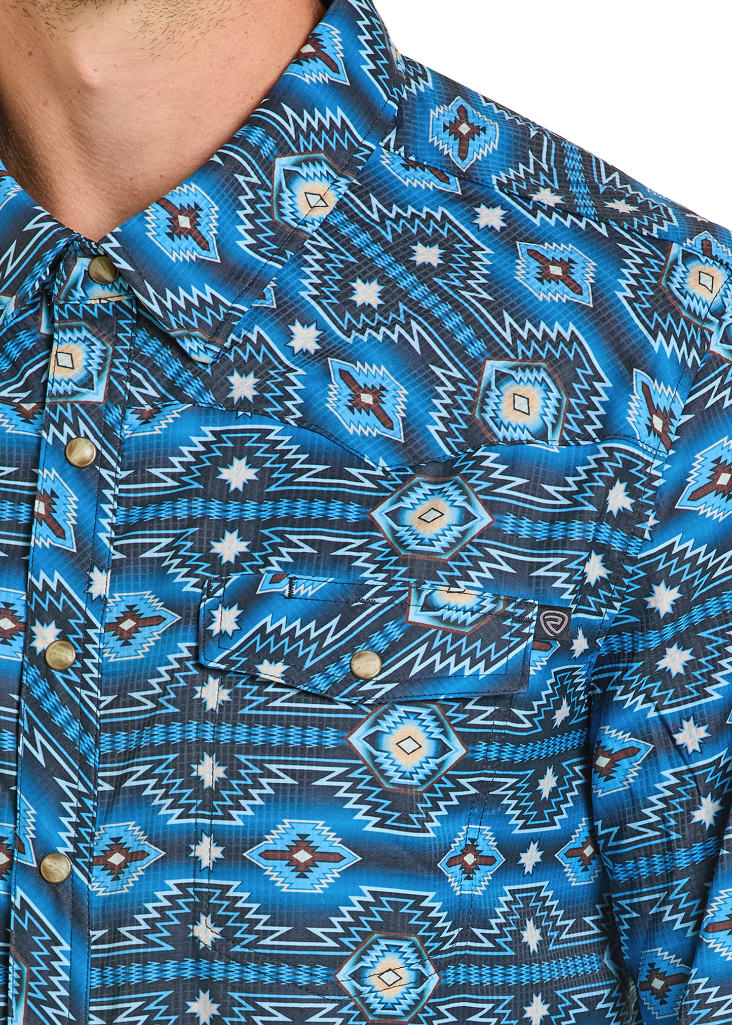 Detail close up of a Western Aztec pearl snap shirt.