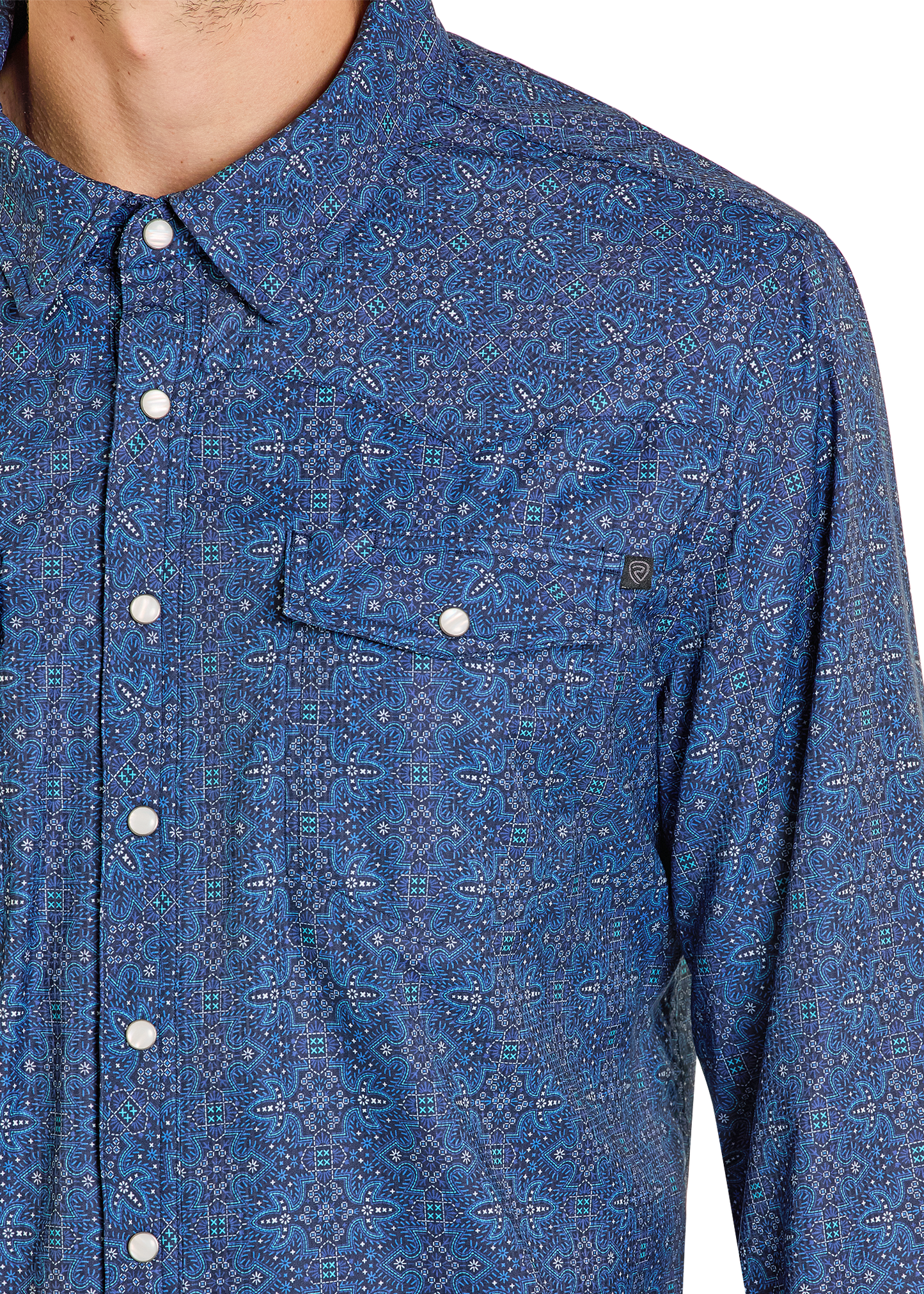 Close-up of a blue patterned shirt with buttons on a white background