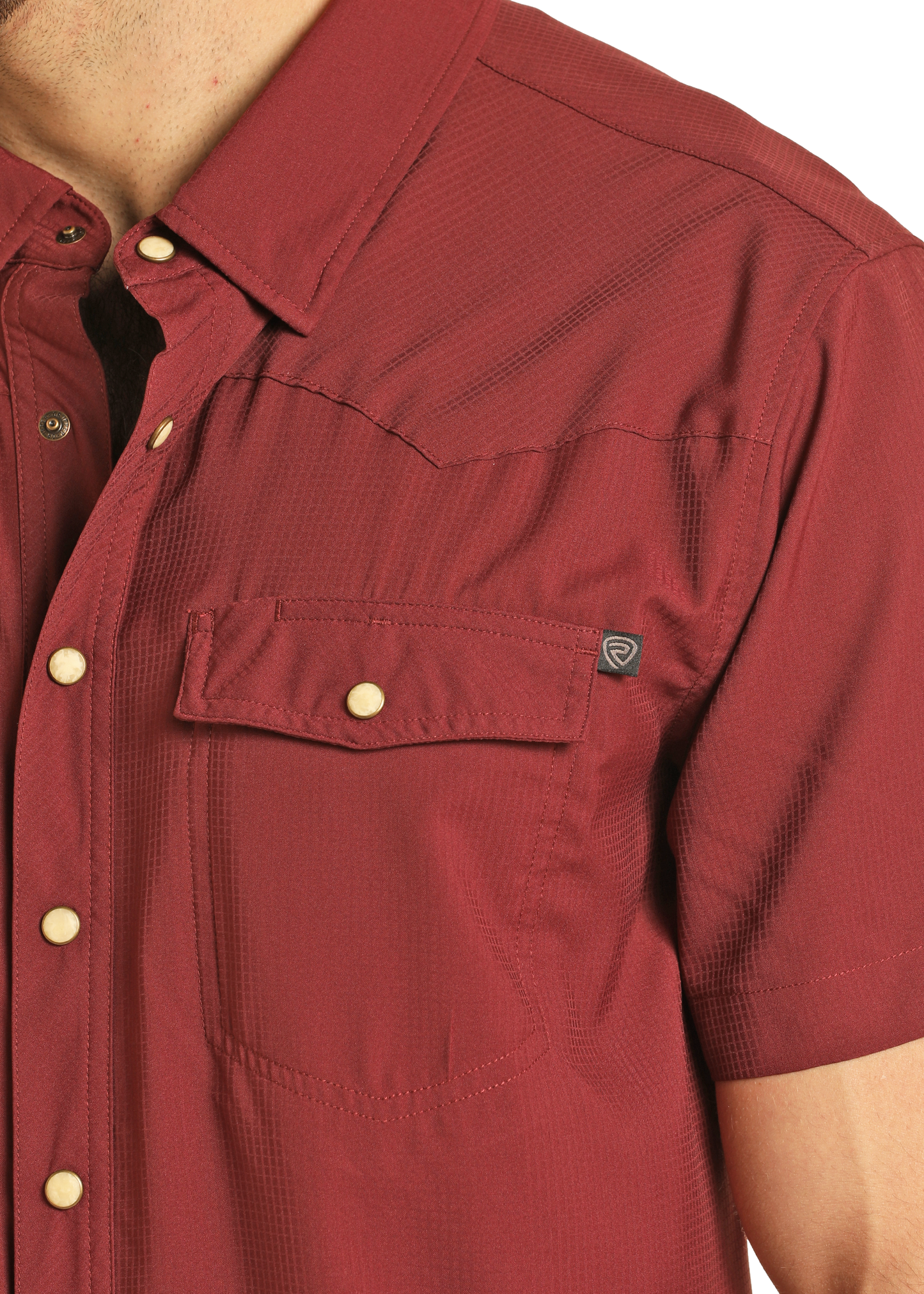 A close-up shows the upper torso and left arm of someone wearing the Rock & Roll Denim TEK Western Maroon Short Sleeve Shirt, featuring white snaps and a front chest pocket.