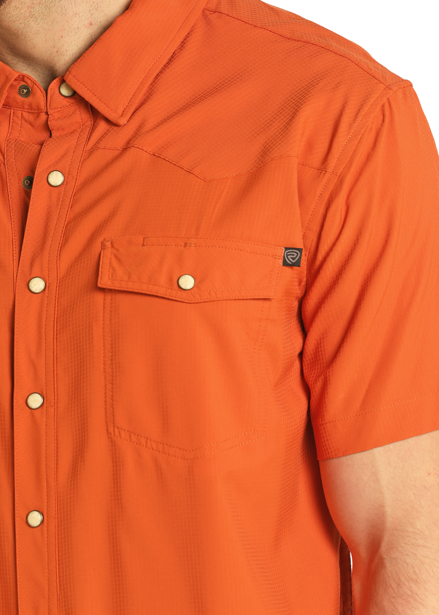 A person wearing the Rock & Roll Denim TEK Western Stretch Orange Short Sleeve Shirt; only their upper torso and part of one arm are visible.