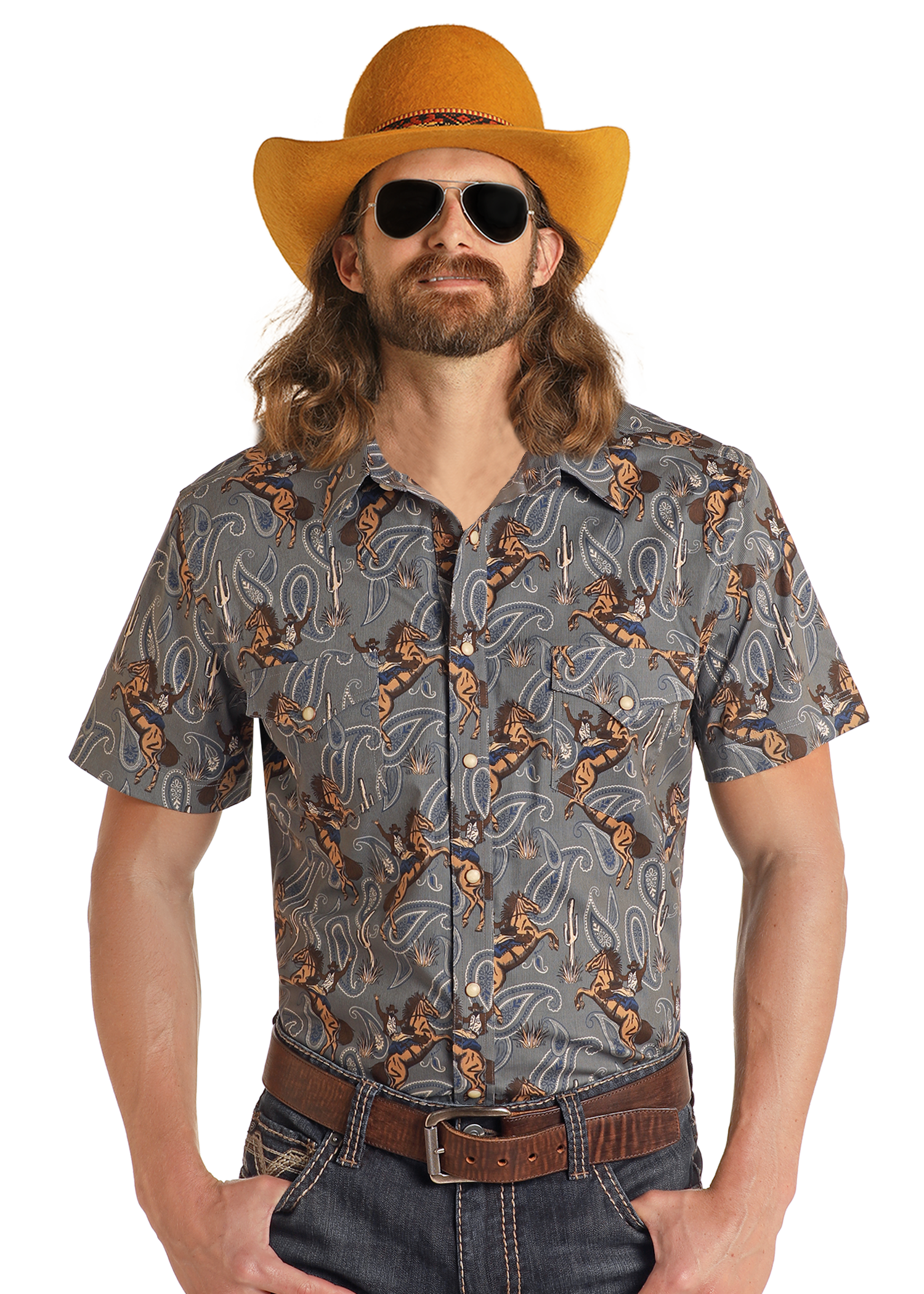 A man with long hair and a beard wears a yellow cowboy hat, sunglasses, jeans, a brown belt, and the Rock & Roll Denim Dale Brisby Slim Fit Cowboy Print Short Sleeve Snap Shirt, standing against a plain white background.