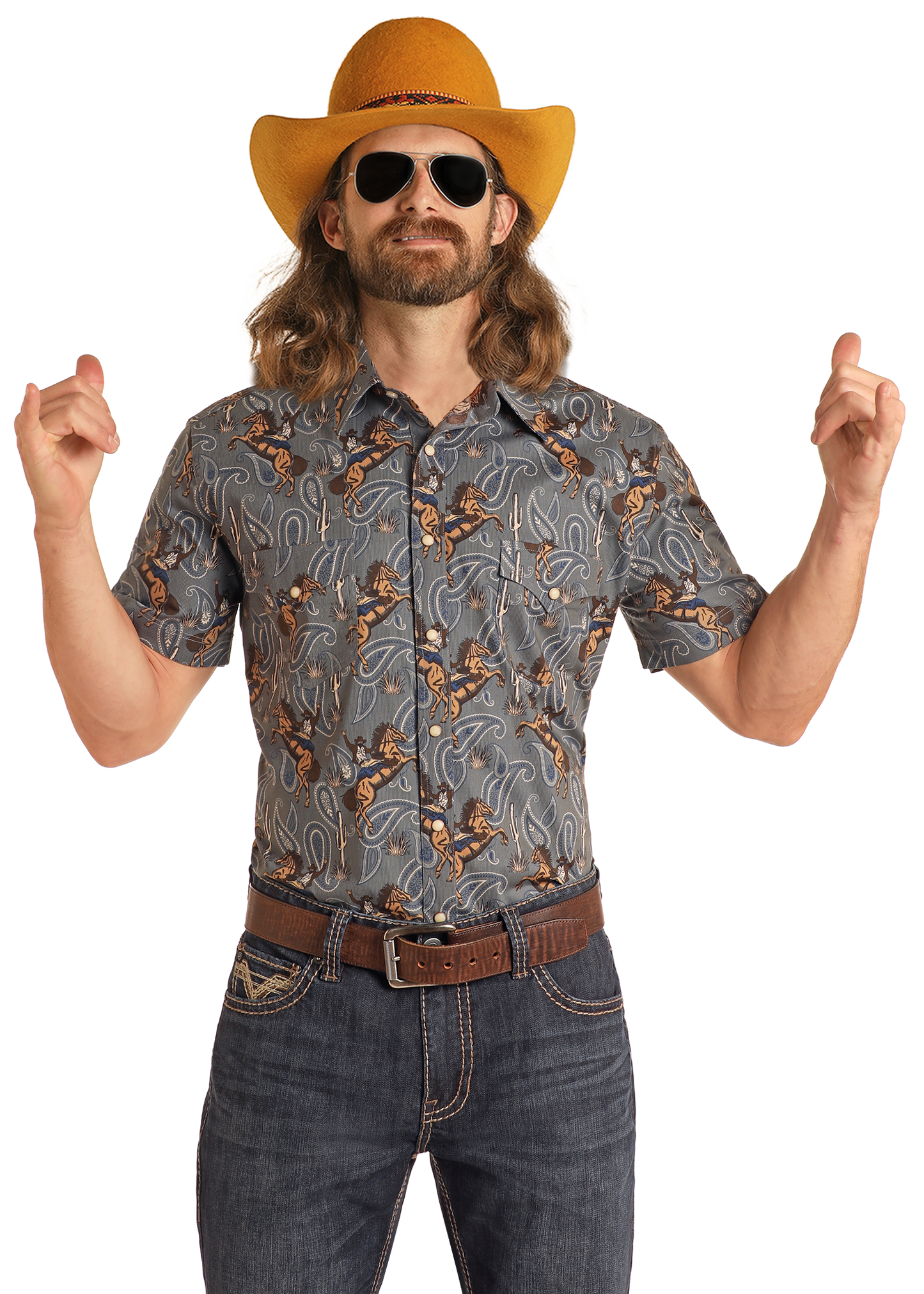 A man with long hair and a beard wears a yellow cowboy hat, sunglasses, jeans, and the Rock & Roll Denim Dale Brisby Slim Fit Cowboy Print Short Sleeve Snap Shirt. He stands confidently with both hands raised and fingers pointing up.