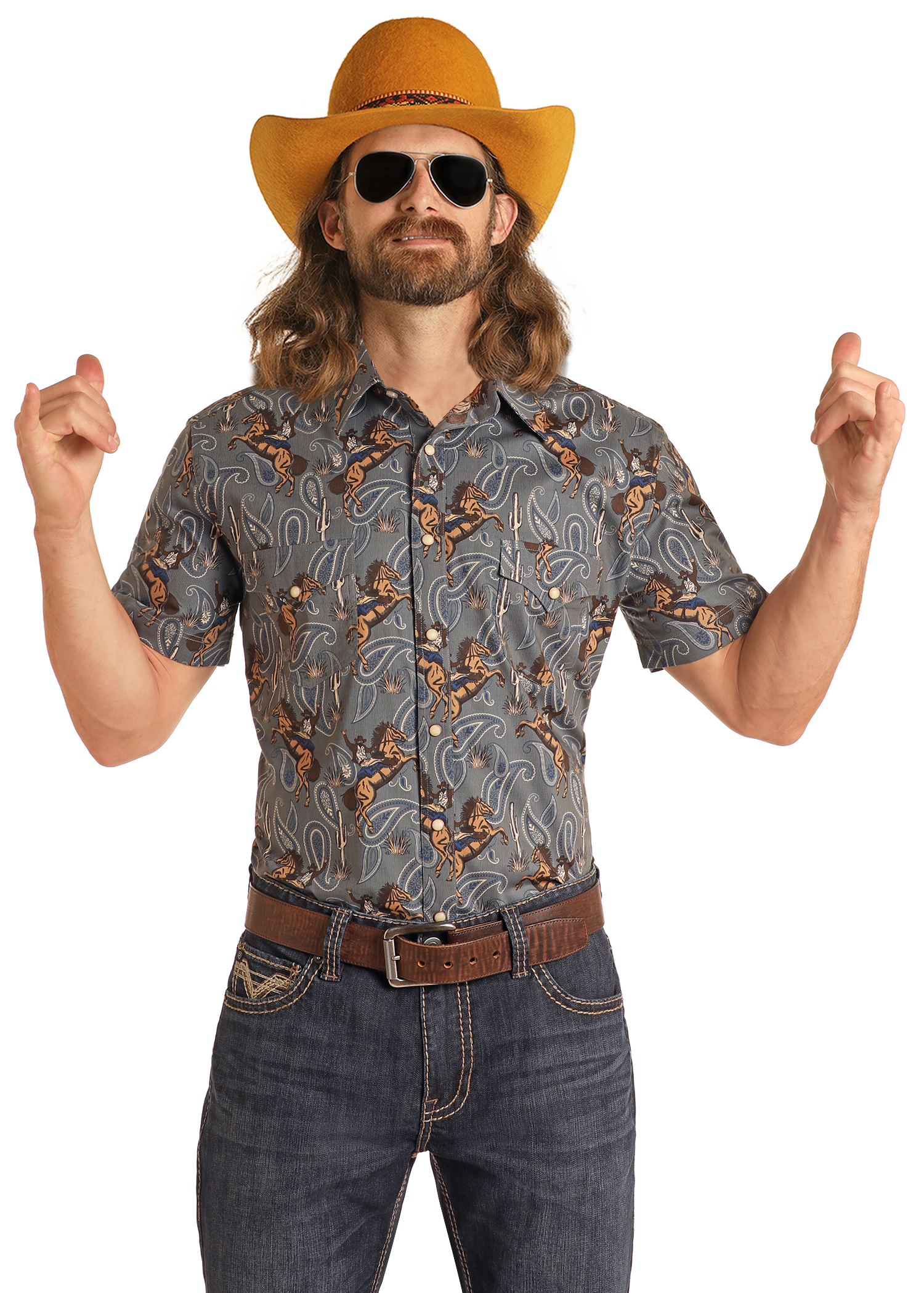A man with long hair and a beard wears a yellow cowboy hat, sunglasses, jeans, and the Rock & Roll Denim Dale Brisby Slim Fit Cowboy Print Short Sleeve Snap Shirt. He stands confidently with both hands raised and fingers pointing up.
