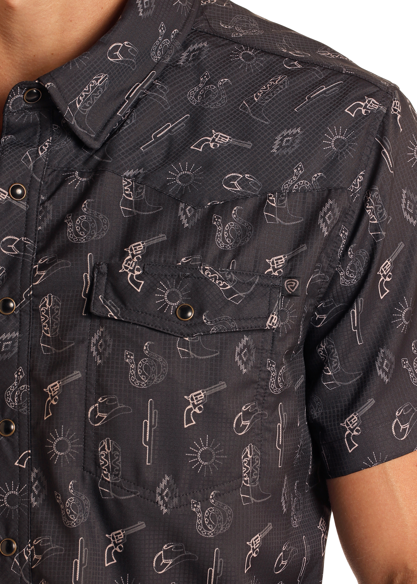 Close-up of the Rock & Roll Denim TEK Western Desert Print Short Sleeve Shirt: a black button-up with white cowboy-themed prints, UPF 50 sun protection, snap buttons, and a chest pocket for style and function.
