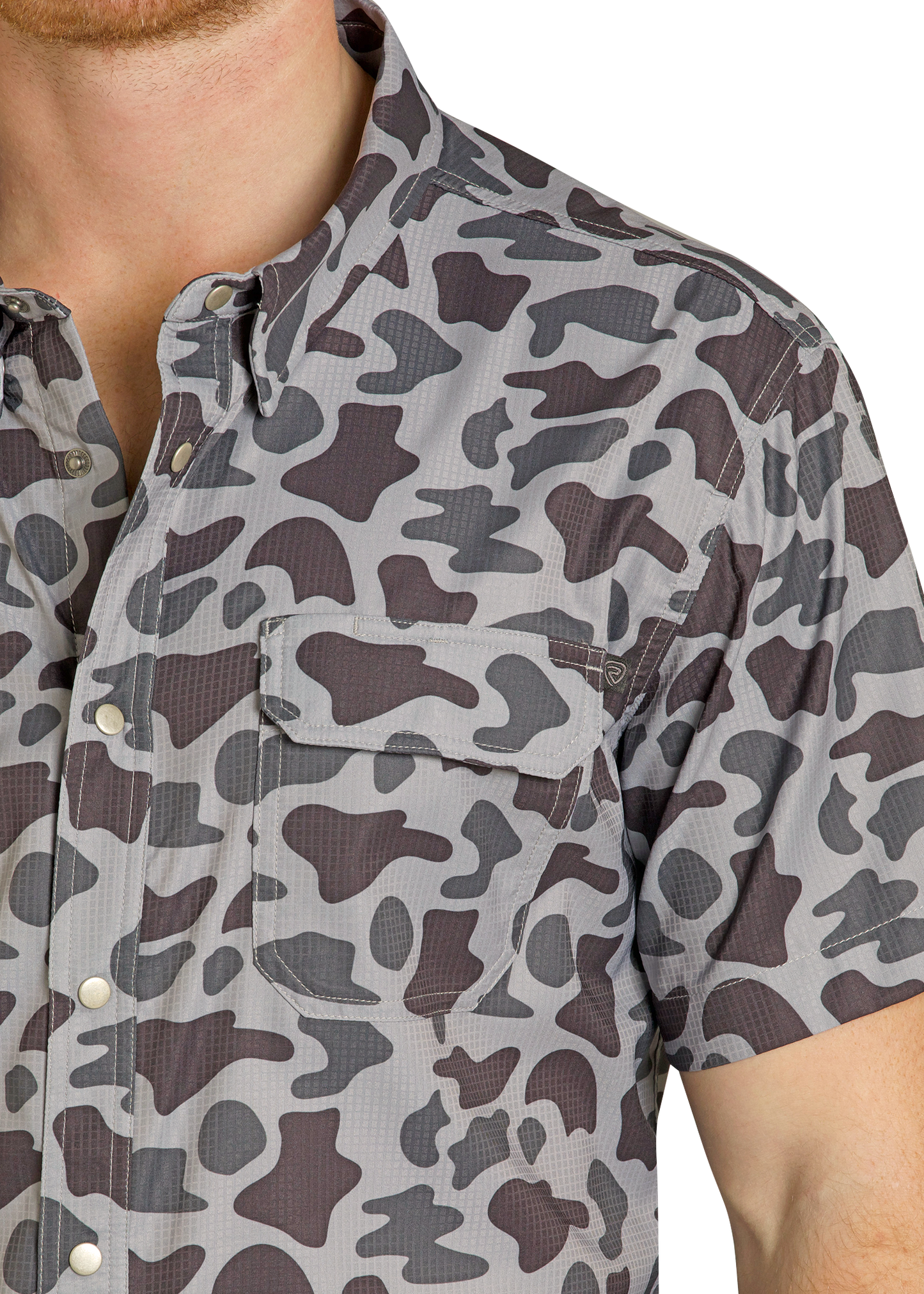 Close-up of a person wearing a camouflage-patterned shirt.