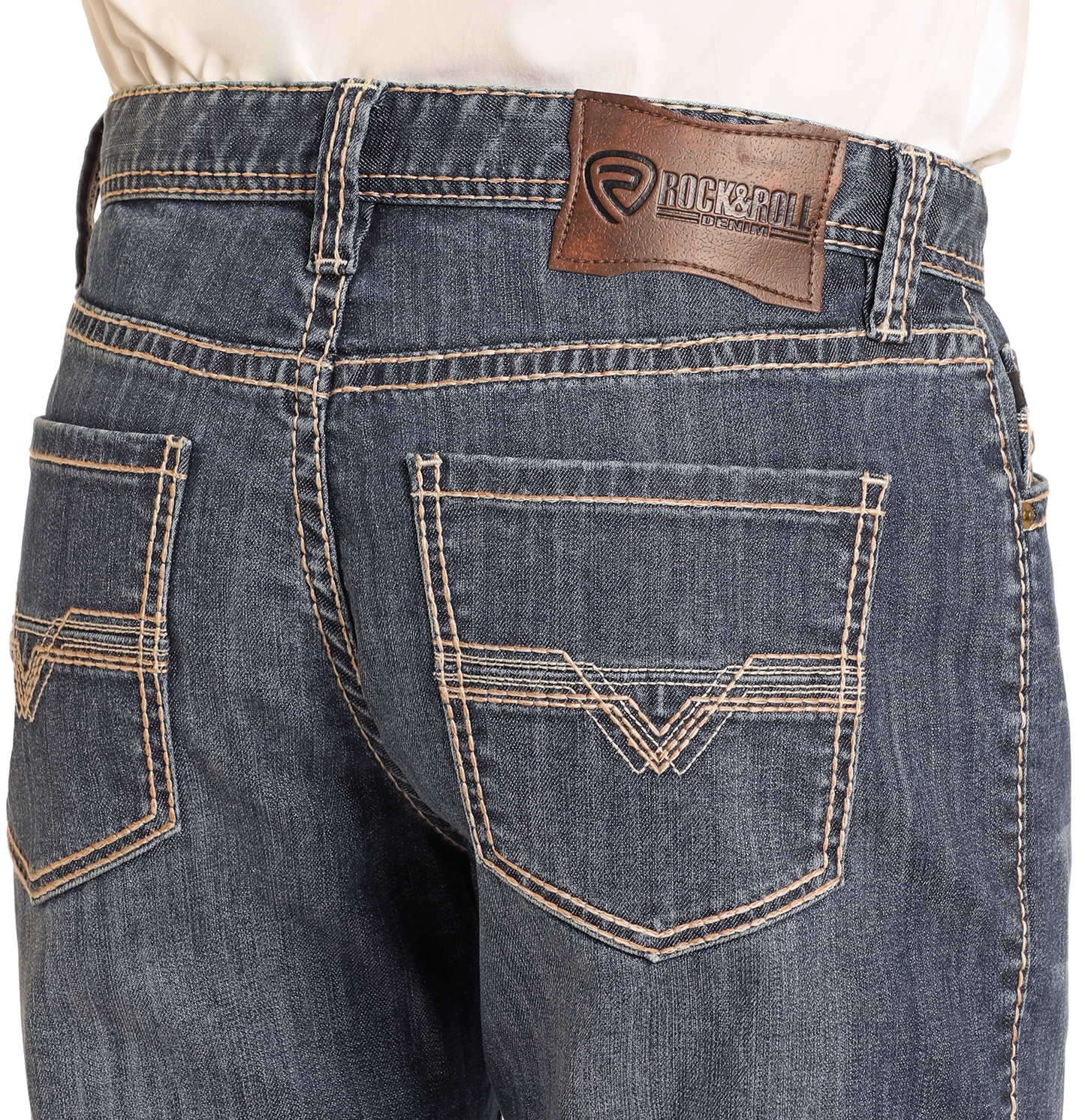 Close-up of the back of a person wearing Rock & Roll Denim Relaxed Fit Small V Stackable Bootcut Jeans in dark wash with tan stitching, two back pockets, and a brown leather Rock & Roll Denim patch on the waistband.