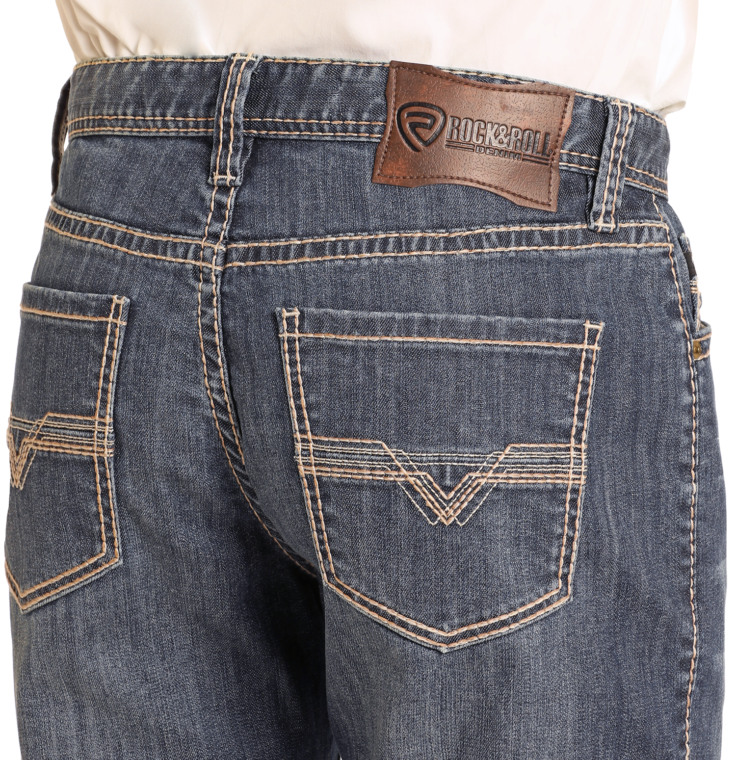 Close-up of the back of a person wearing Rock & Roll Denim Relaxed Fit Small V Stackable Bootcut Jeans in dark wash with tan stitching, two back pockets, and a brown leather Rock & Roll Denim patch on the waistband.