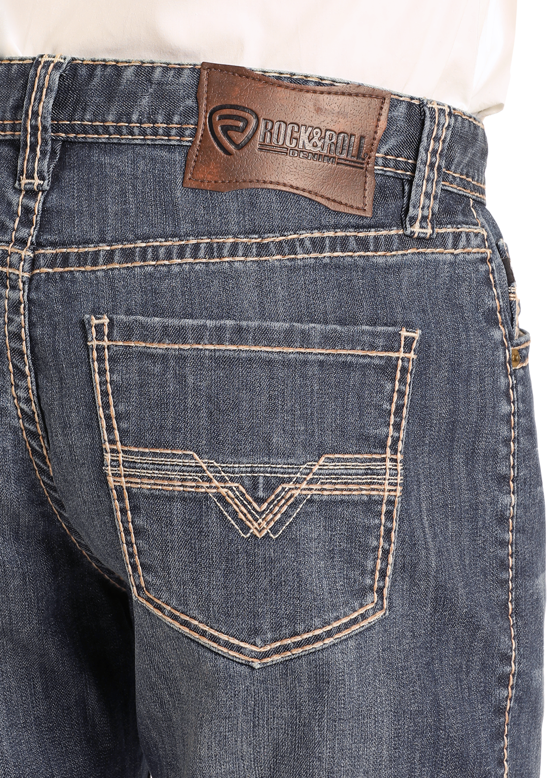 Close-up of the back of a person wearing Rock & Roll Denim Relaxed Fit Small V Stackable Bootcut Jeans in dark wash with tan stitching, two back pockets, and a brown leather Rock & Roll Denim patch on the waistband.