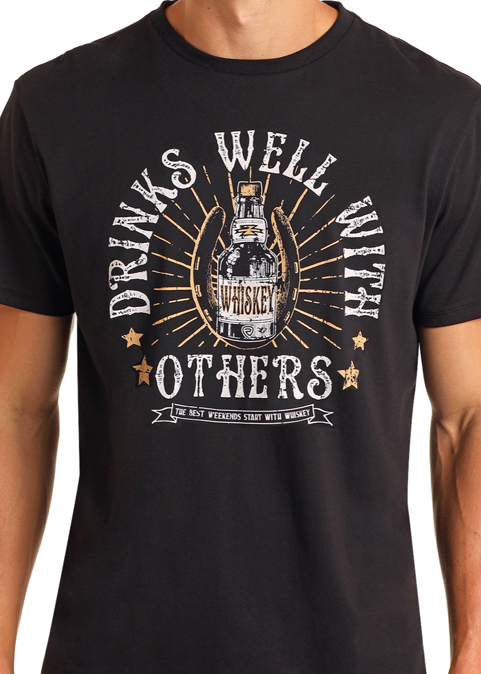 Wearing the Rock & Roll Denim Drinks Well With Others Graphic Tee—a black shirt with a whiskey bottle graphic and bold lettering—someone enjoys its comfort, making it ideal for daily use and relaxed weekends with friends.