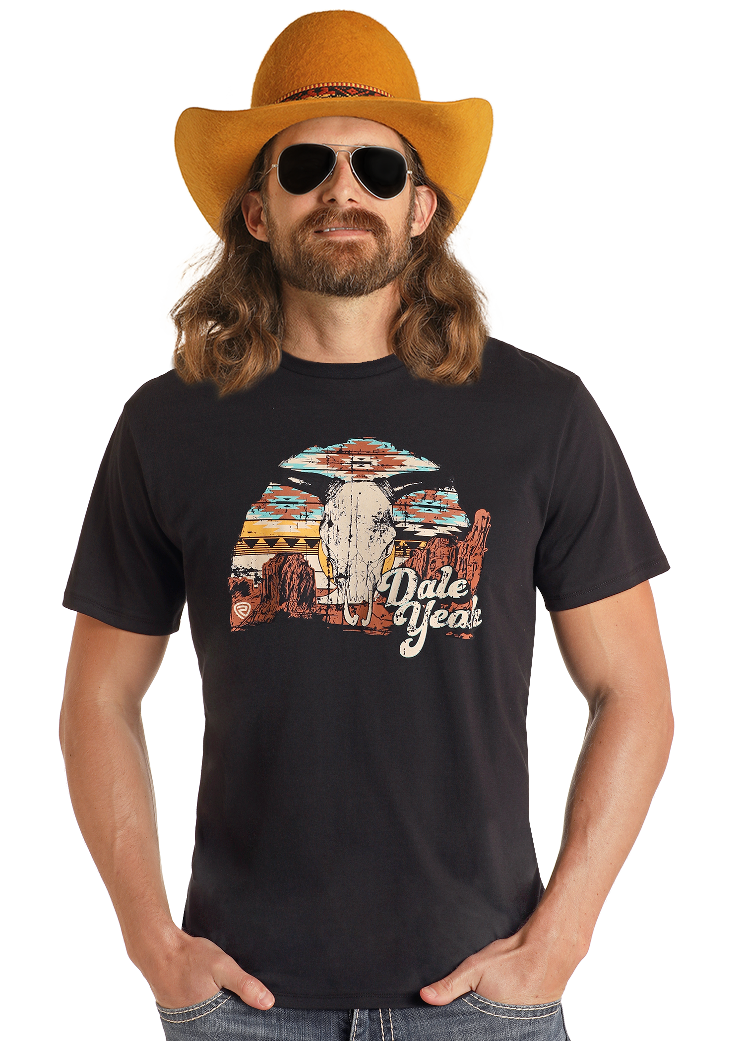 A man with long hair and a beard wears a yellow cowboy hat, black sunglasses, and the Rock & Roll Denim Dale Brisby Black Dale Yeah Graphic Tee (size S), featuring a colorful desert scene. He smiles slightly with his hands in his pockets.