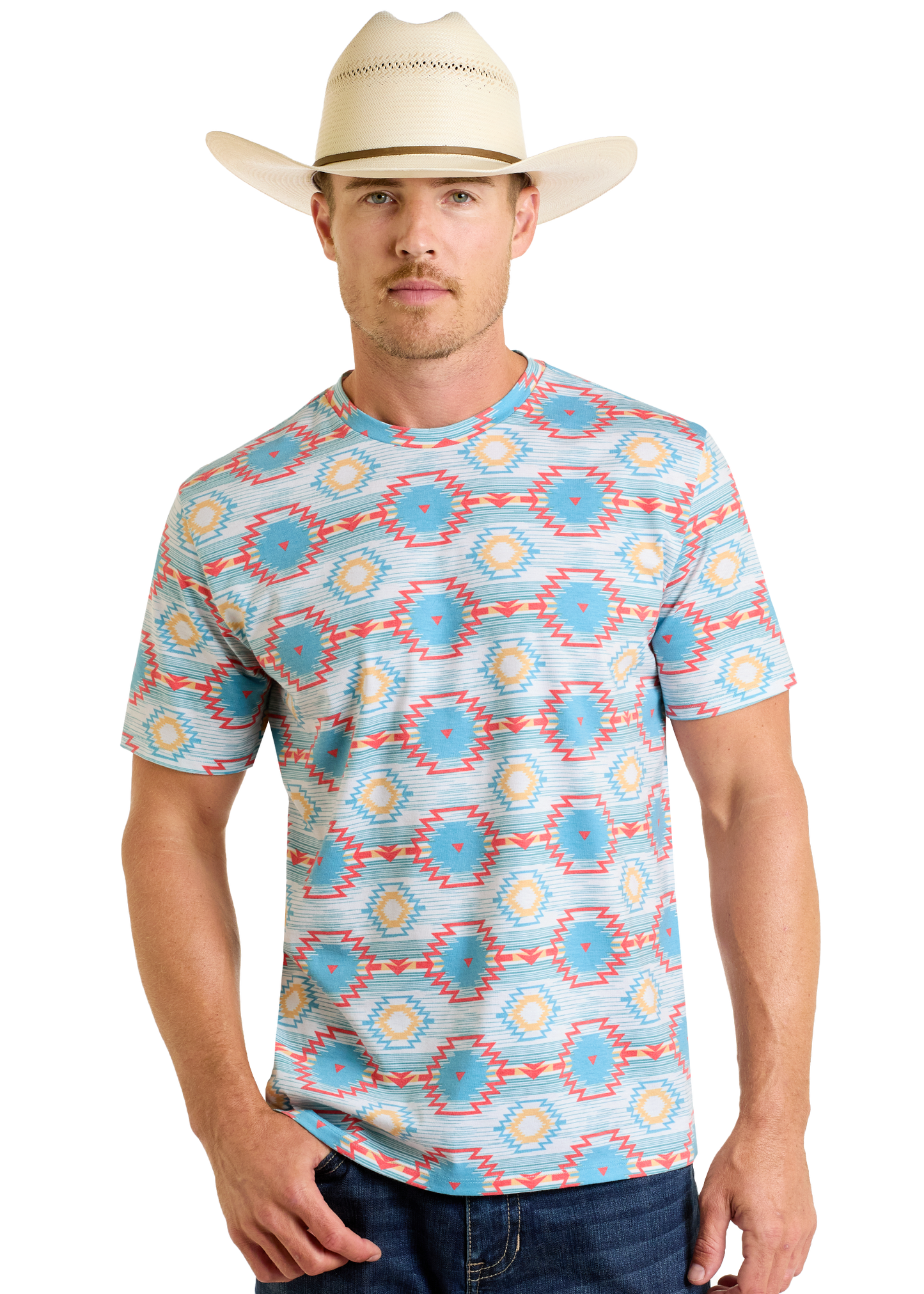 A man wearing a cream cowboy hat, blue jeans, and a Rock & Roll Denim Turquoise Aztec All Over Print Tee stands facing forward against a plain white background.
