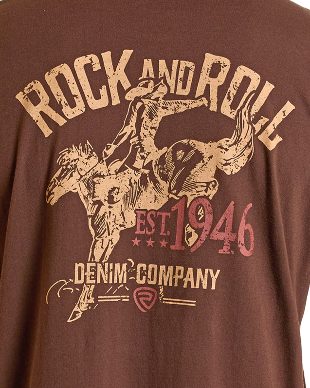 The Rock & Roll Denim 1946 Bronco Graphic Tee features a cowboy riding a bucking horse with “ROCK AND ROLL, EST. 1946, DENIM COMPANY” text—perfect for everyday comfort and style.