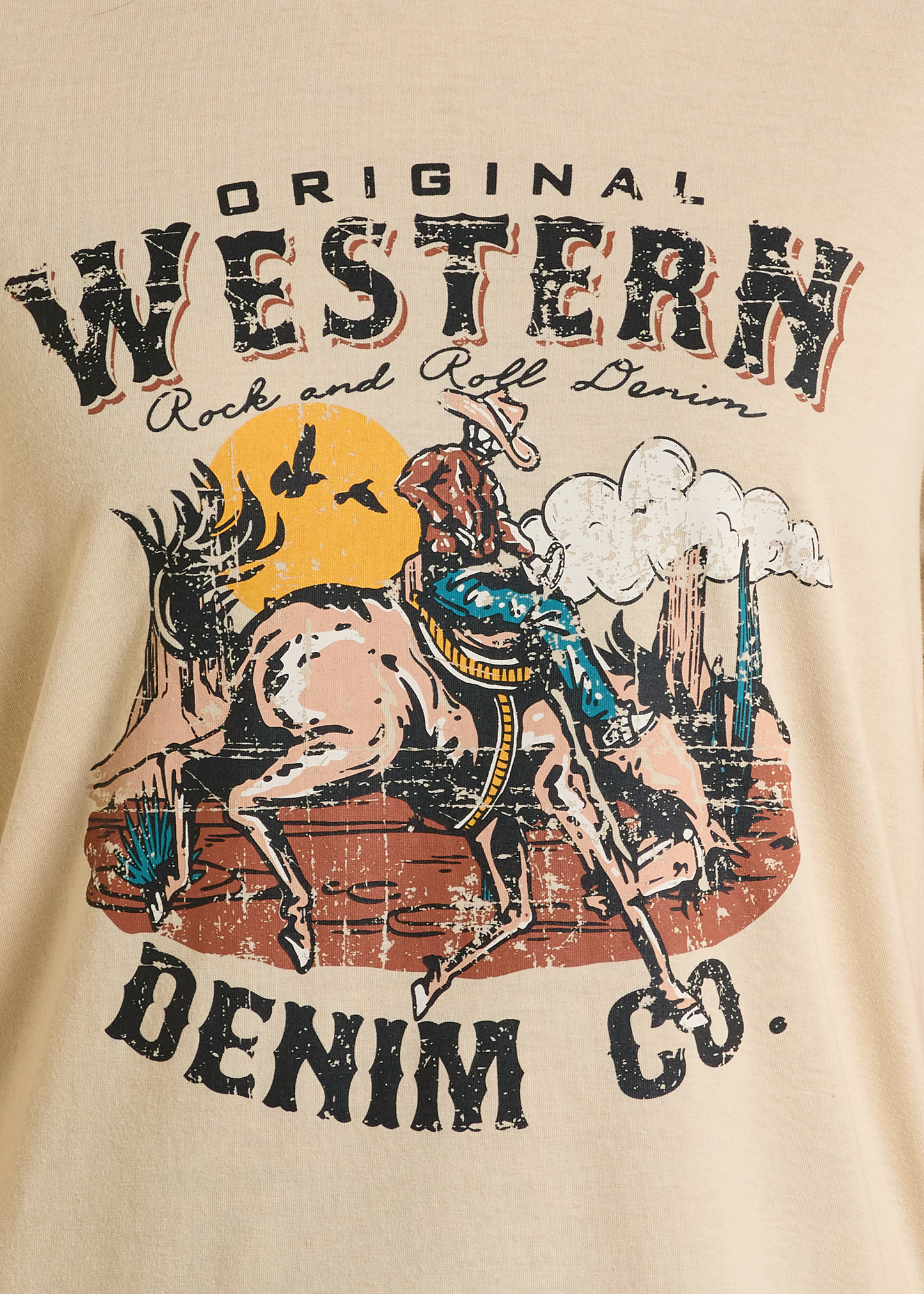 This Original Western Denim Co. Graphic Tee by Rock & Roll Denim features a cowboy on a bucking horse with sunset, clouds, and birds, plus distressed vintage lettering—ideal for any western or graphic tee collection.