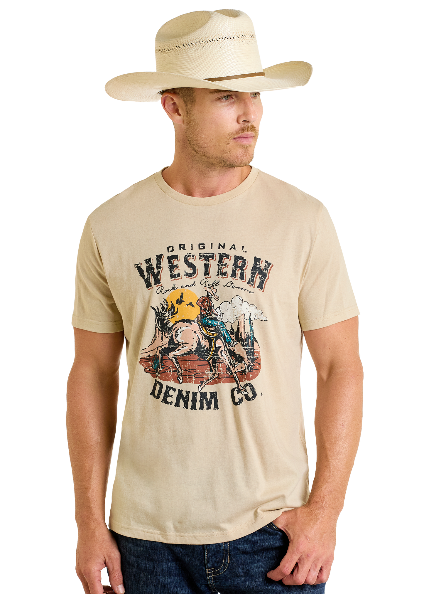 A man in a light cowboy hat and jeans wears the Rock & Roll Denim Original Western Denim Co. Graphic Tee, featuring a horse-and-desert design, while looking to the side.