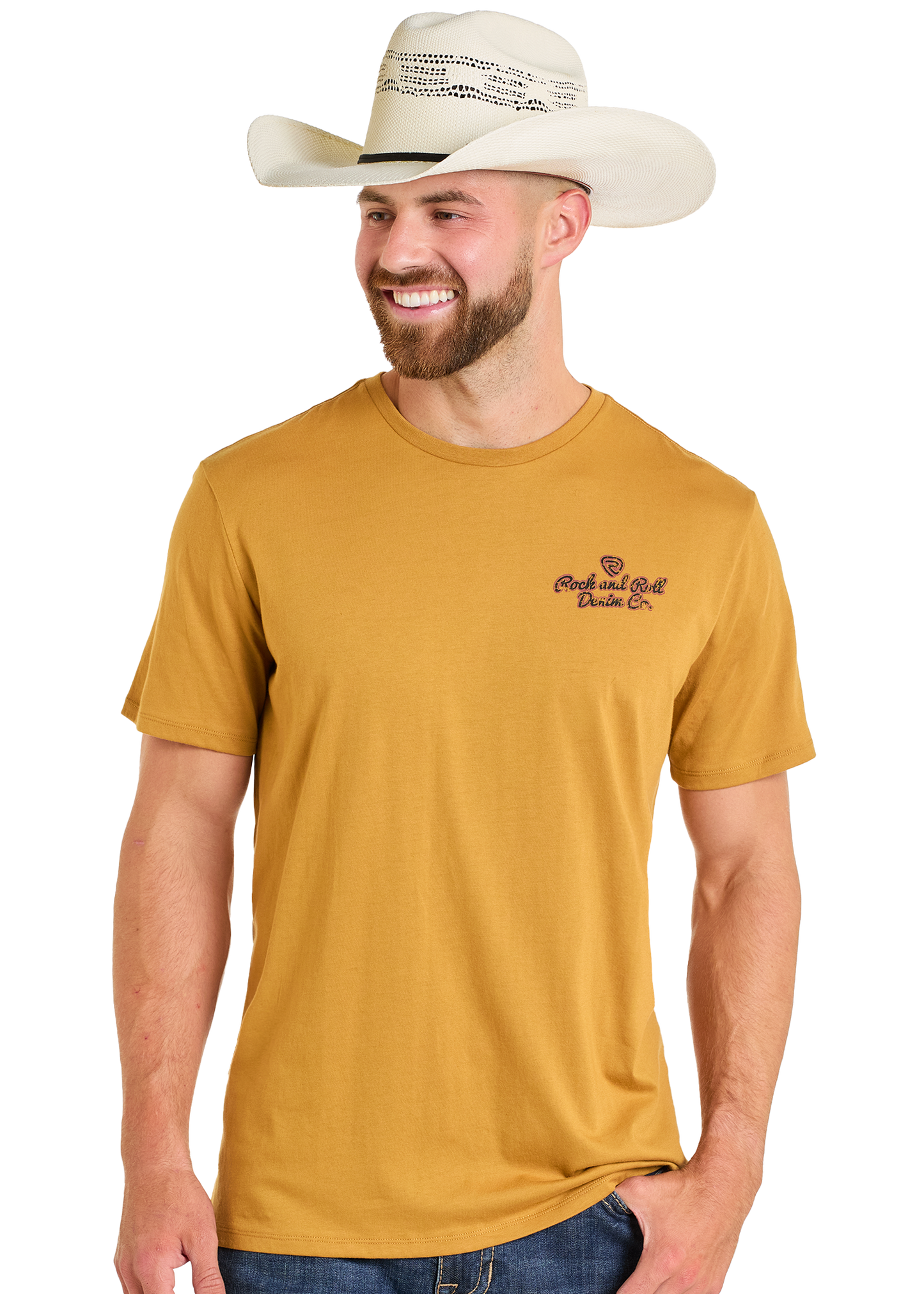 A smiling man in a white cowboy hat, blue jeans, and the Rock & Roll Denim Original Western Denim Co Unisex Graphic Tee with small chest text stands against a plain white background.