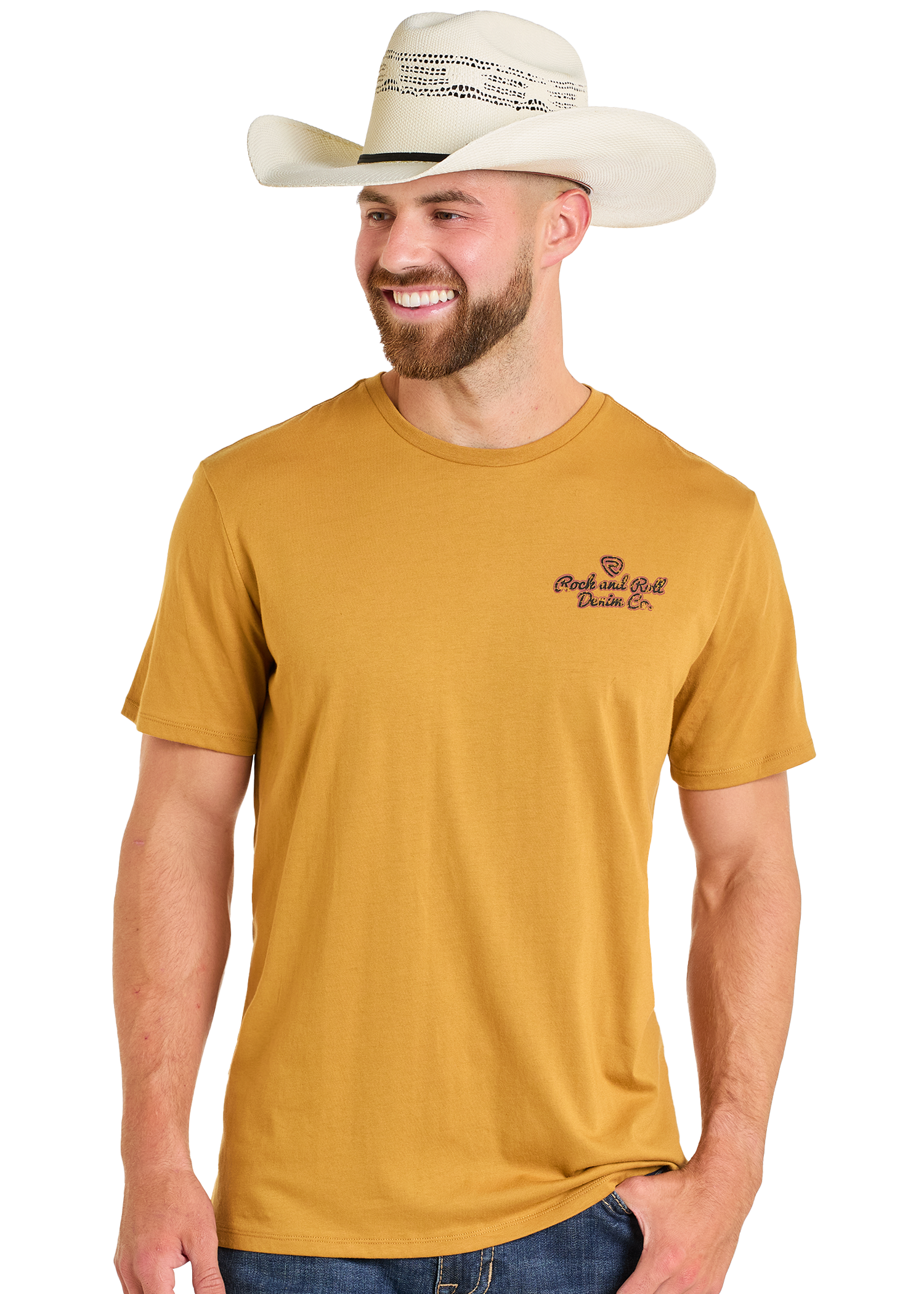 A smiling man in a white cowboy hat, blue jeans, and the Rock & Roll Denim Original Western Denim Co Unisex Graphic Tee with small chest text stands against a plain white background.