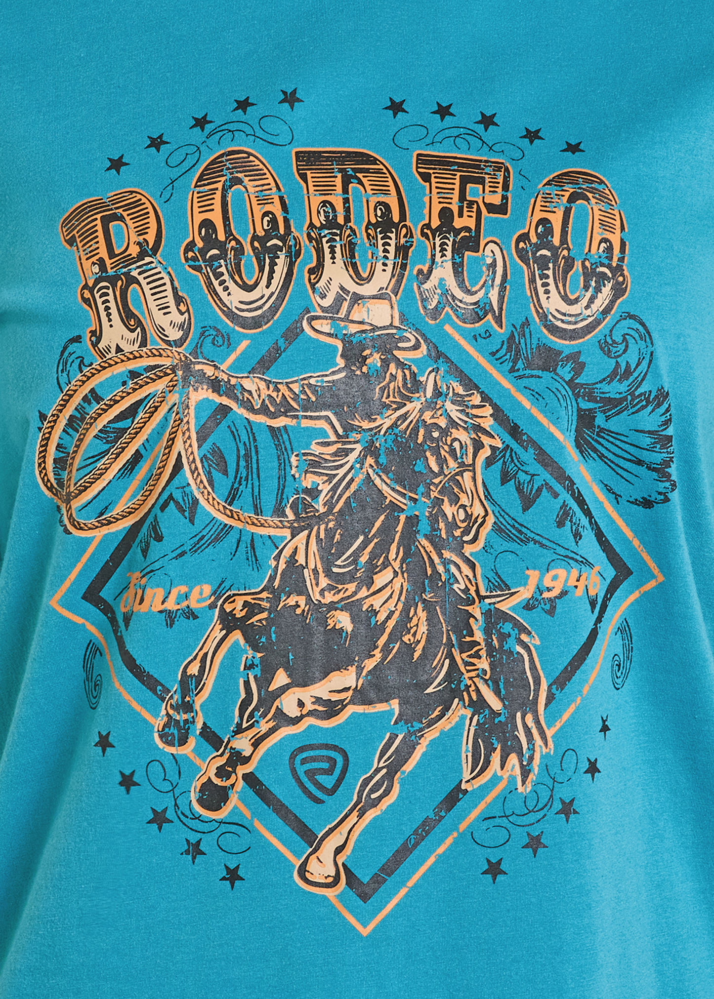 The Turquoise Rodeo Graphic Tee by Rock & Roll Denim features a vintage cowboy on a bucking horse with lasso, “RODEO” above, and “since 1946” below. A comfortable everyday tee.