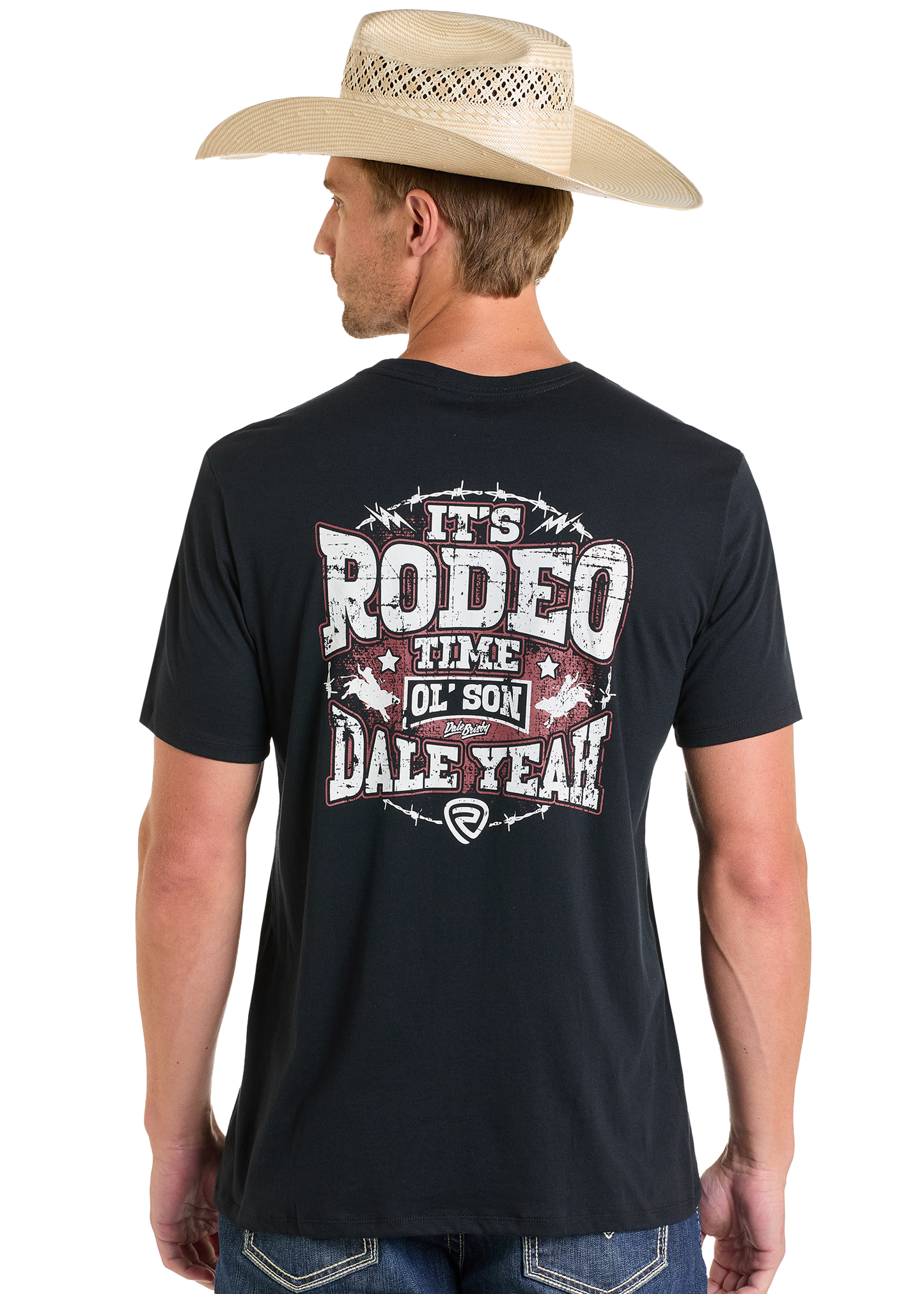A man in a cowboy hat and black Rock & Roll Denim Dale Brisby It's Rodeo Time Graphic Tee is seen from behind. The shirt features bold, distressed "It's Rodeo Time Ol Son DALEYEAH!" text with stars and barbed wire graphics.