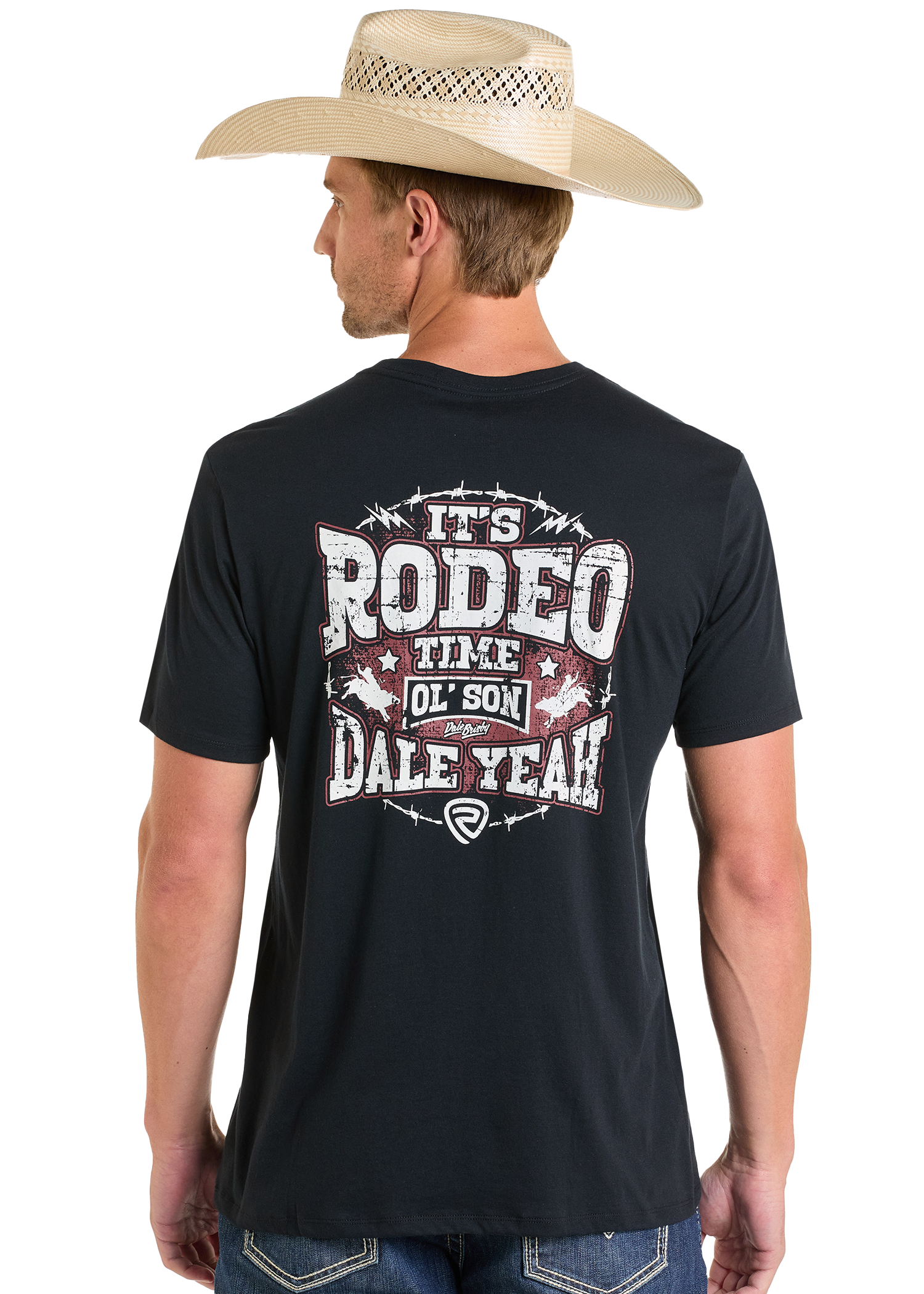 A man in a cowboy hat and black Rock & Roll Denim Dale Brisby It's Rodeo Time Graphic Tee is seen from behind. The shirt features bold, distressed "It's Rodeo Time Ol Son DALEYEAH!" text with stars and barbed wire graphics.