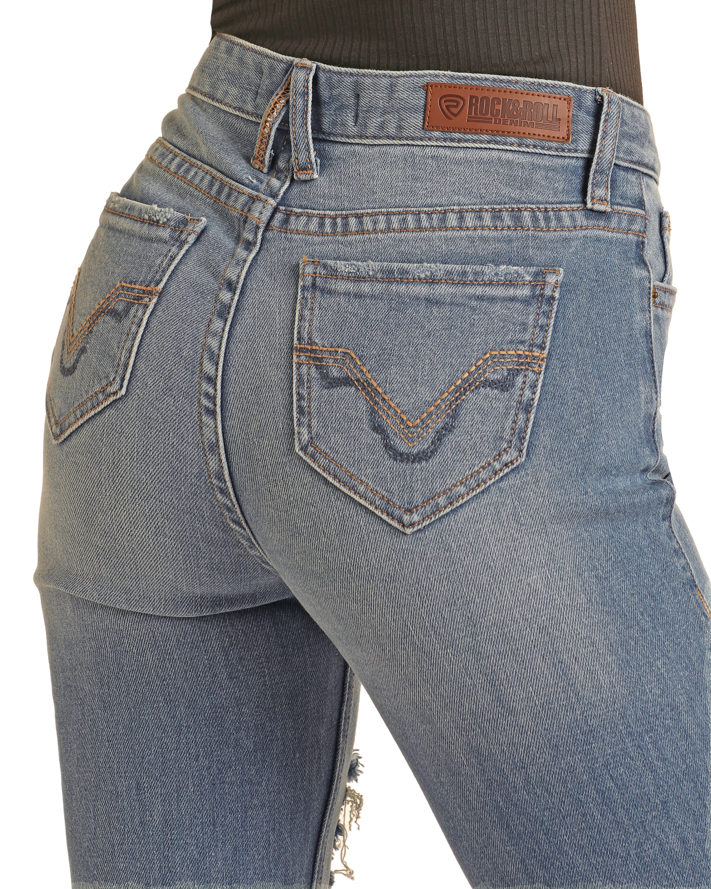 Close-up of a person in Rock & Roll Denim's West Desperado Distressed Denim High Rise Bootcut Jeans with tan stitching, back pockets, and brown brand patch. The cotton-polyester blend is paired with a tucked-in dark ribbed top.