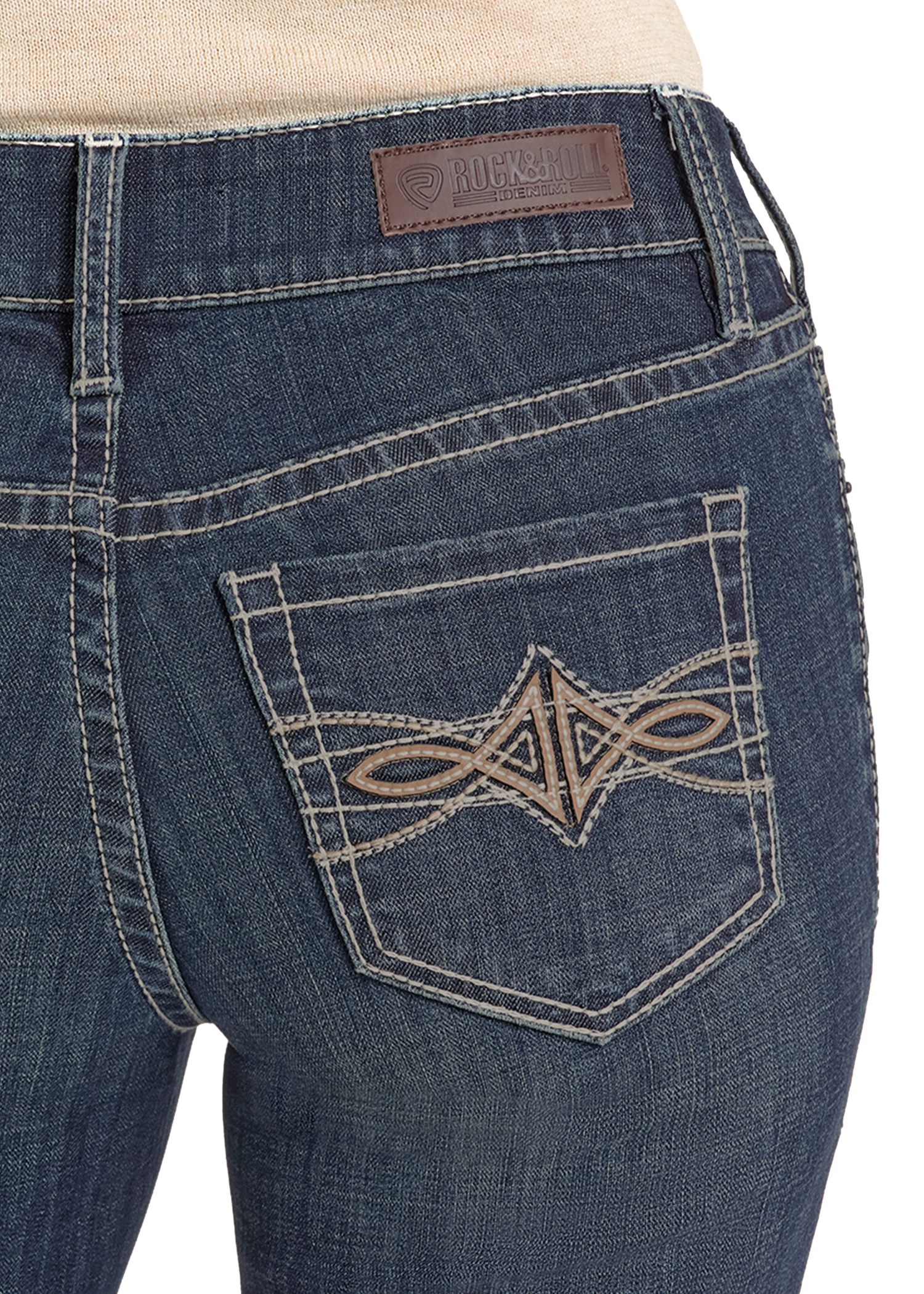 Close-up of the back of Rock & Roll Denim Mid Rise Leather Embroidered Pocket Modest Bootcut Jeans, featuring detailed beige stitching and a brown rectangular leather patch at the waistband.