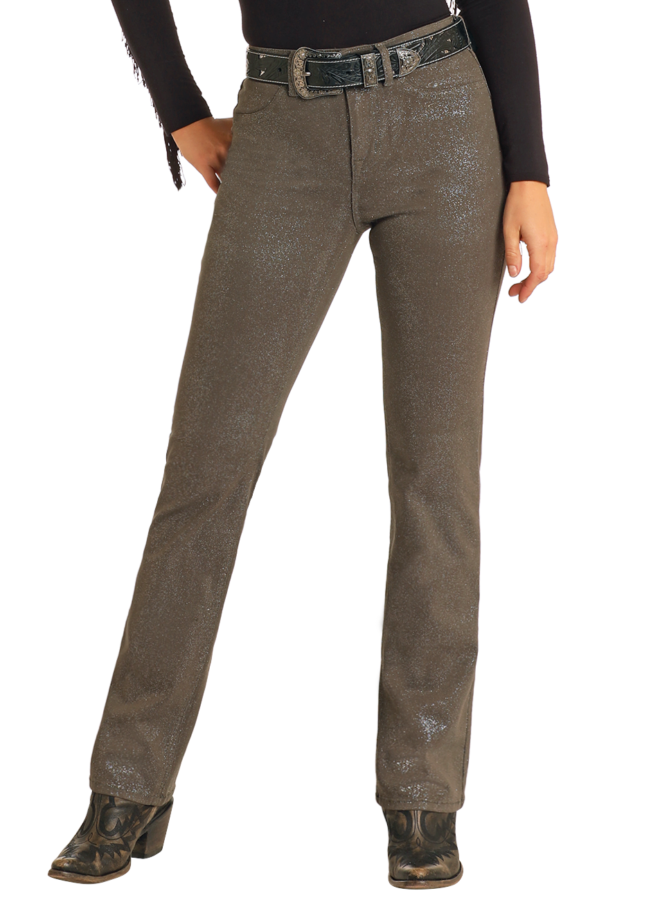 A person wearing Rock & Roll Denim Glitter Extra Stretch Modest Bootcut Jeans in metallic brown, paired with a black belt, black long-sleeve top, and black heeled boots, poses against a white background.