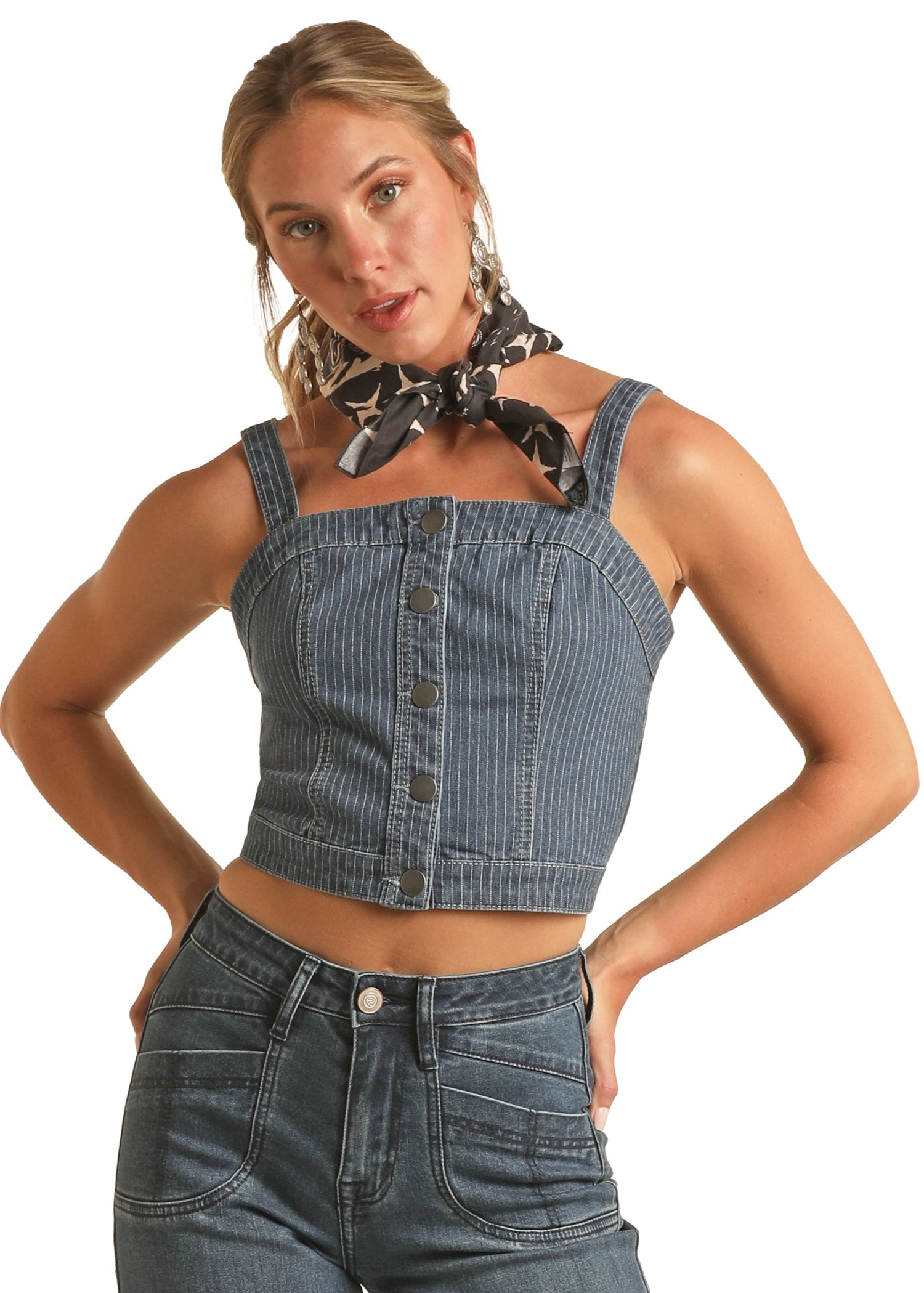 Woman wearing a denim top and jeans with a white background